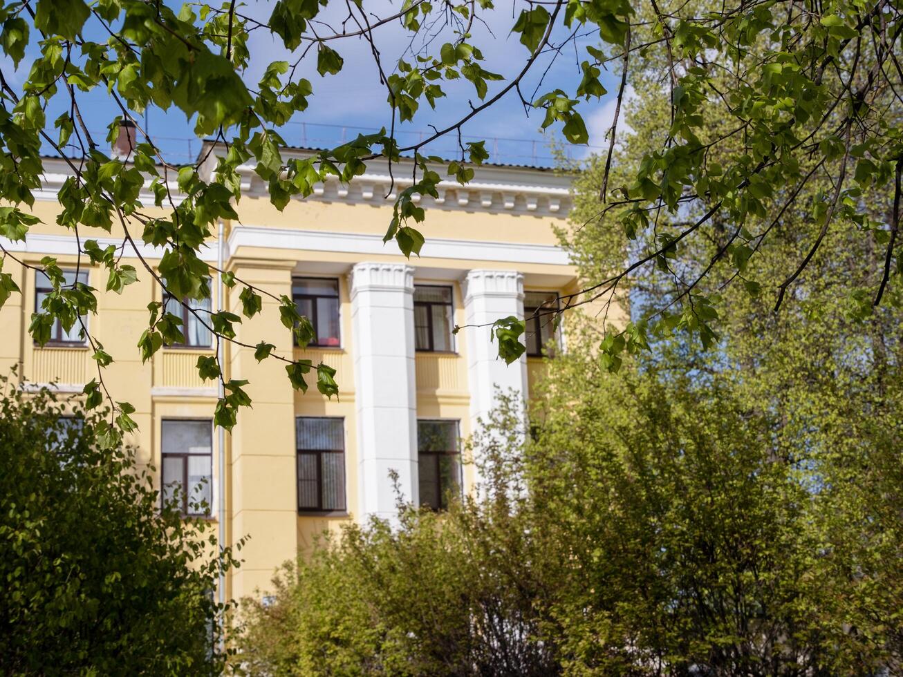 fragment of yellow administrative building on sunny day, selective focus photo