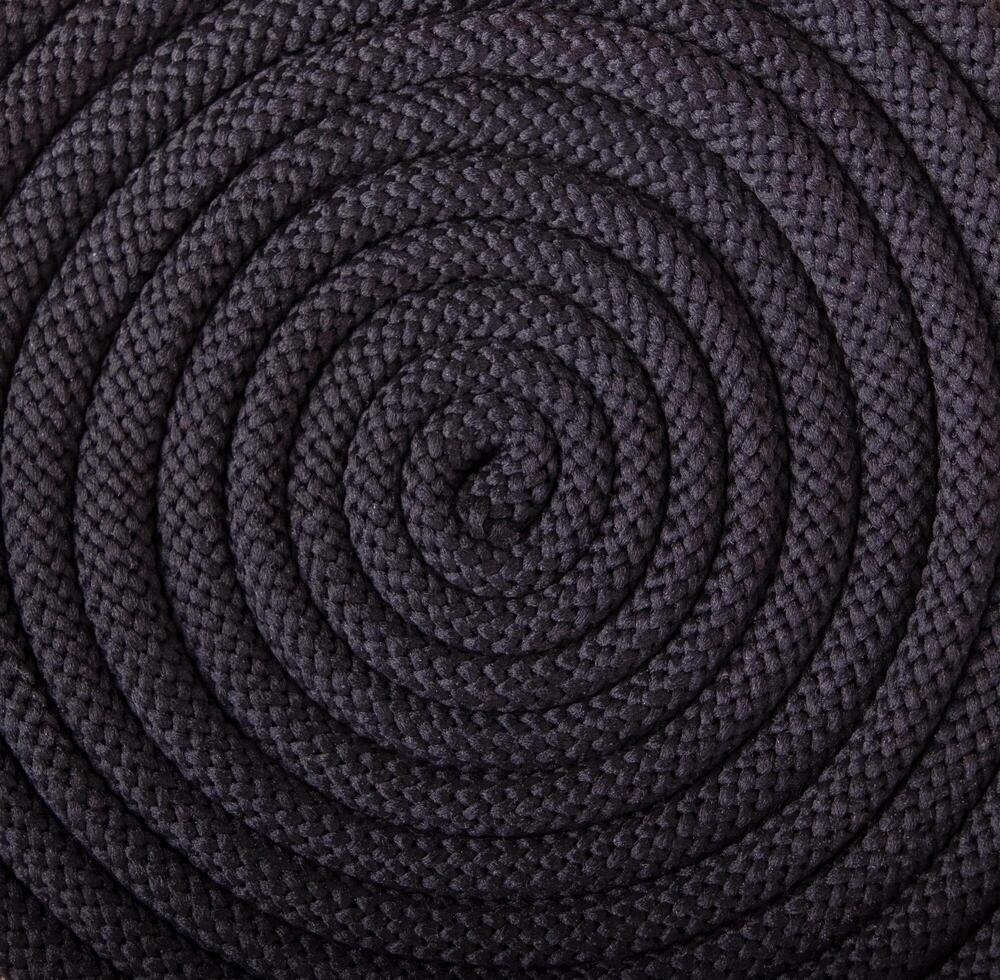 black textured cord laid in a spiral, circular pattern photo