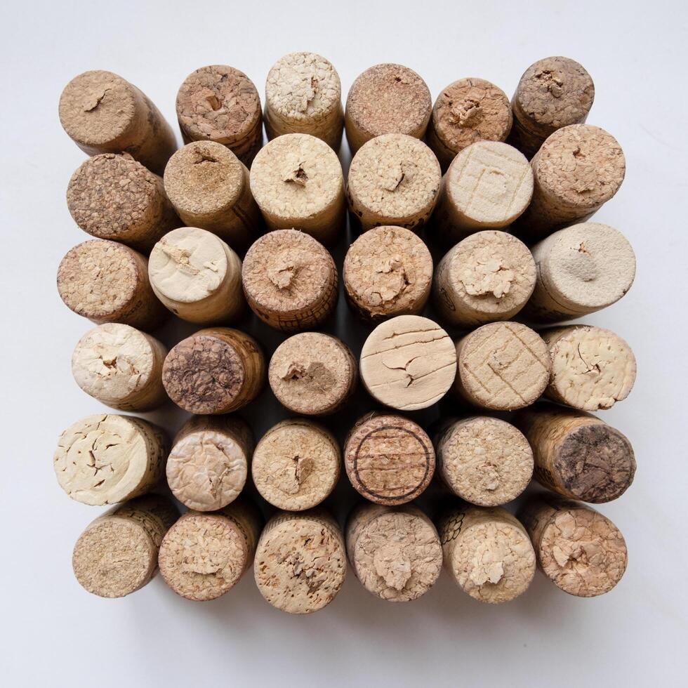 square made of wine corks on white background, geometric textured pattern photo