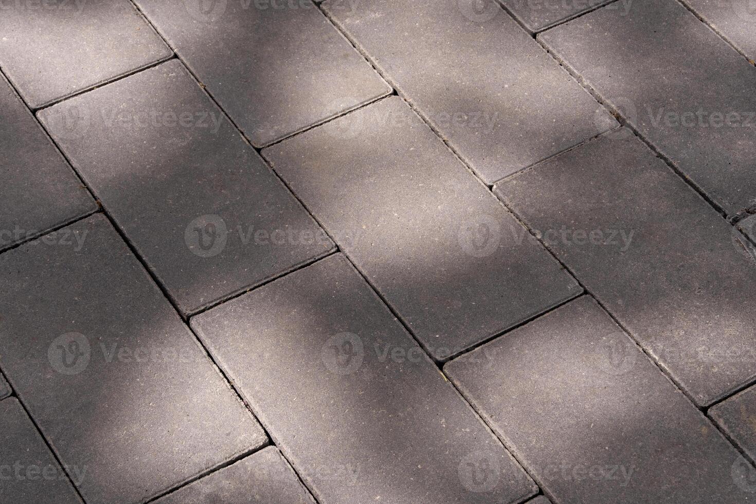road made of rectangular stone blocks, in the shade of trees, copy space photo
