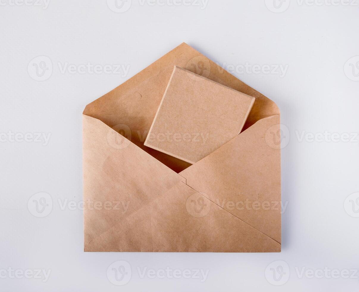 cardboard box in a kraft envelope, on a white background photo