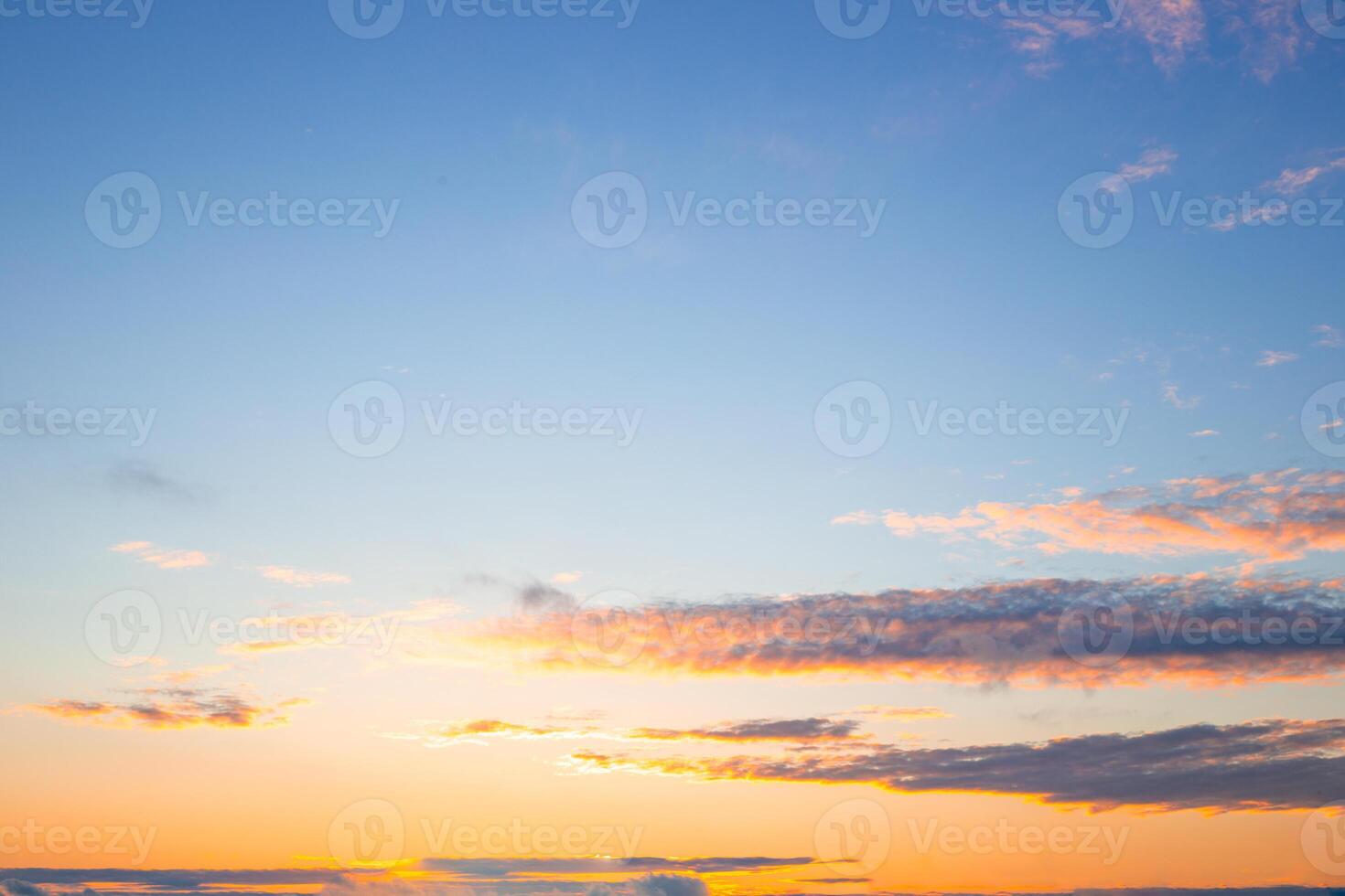 Celestial landscape. Blue evening sky with illuminated clouds at sunset. photo