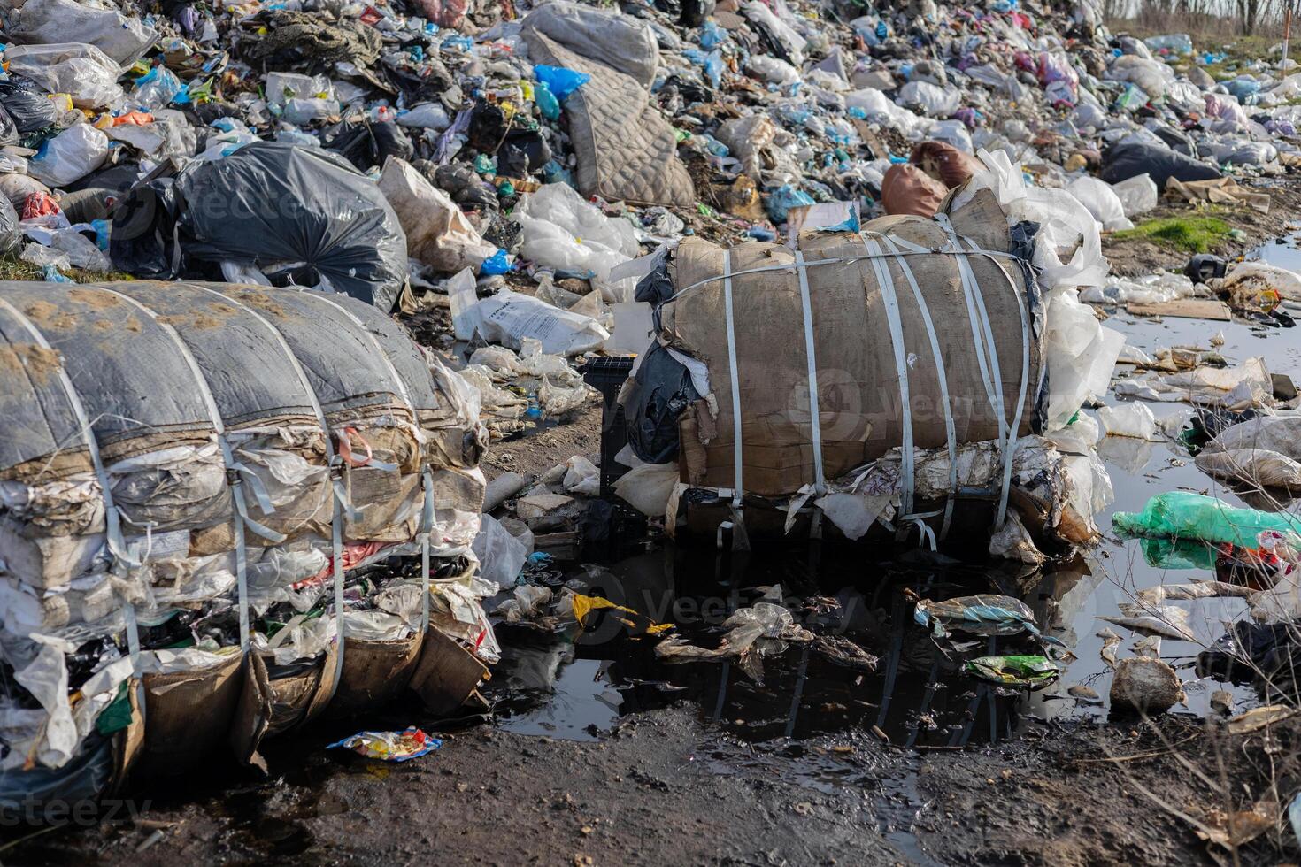 Large piles of waste and discarded materials fill the landscape, highlighting the pressing issue of pollution and improper waste management photo