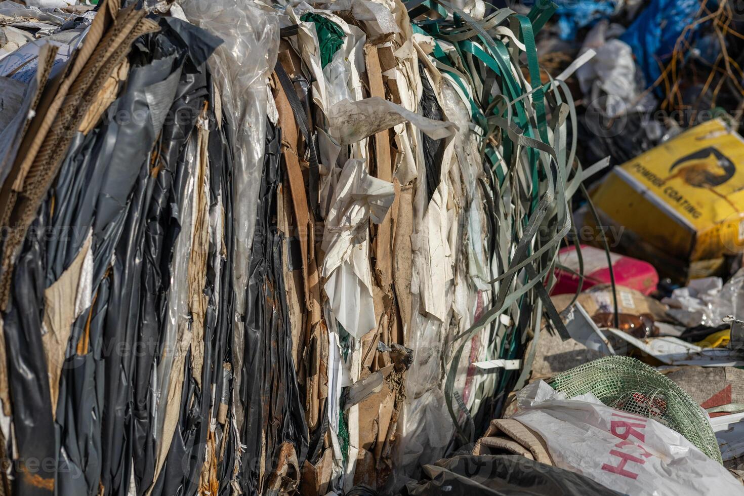 Piles of compressed waste materials are seen at a recycling center, showcasing the critical issue of waste management in cities photo