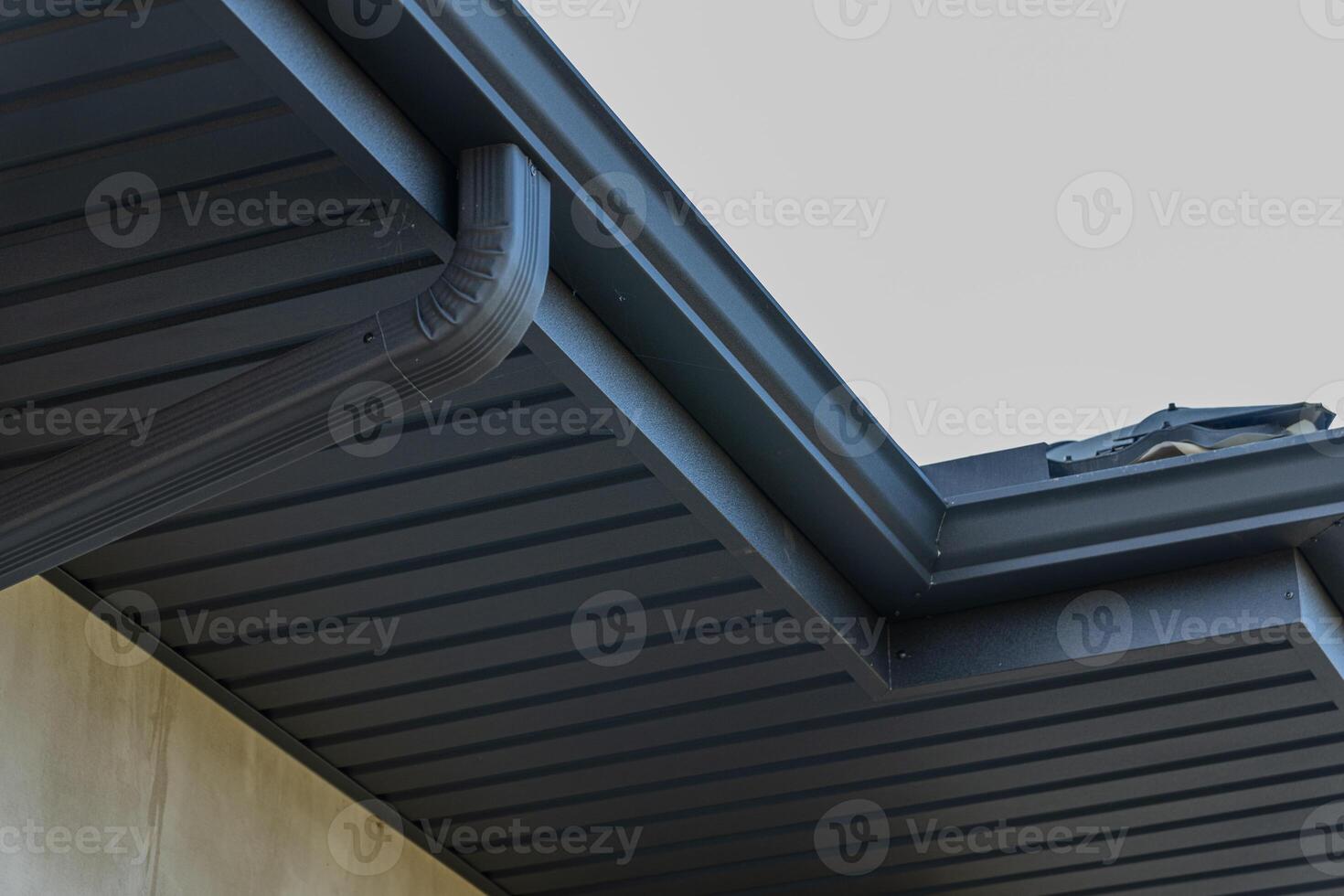 Close-up view showcases a contemporary roof edge with a smooth finish, highlighting architectural details in bright sunlight photo