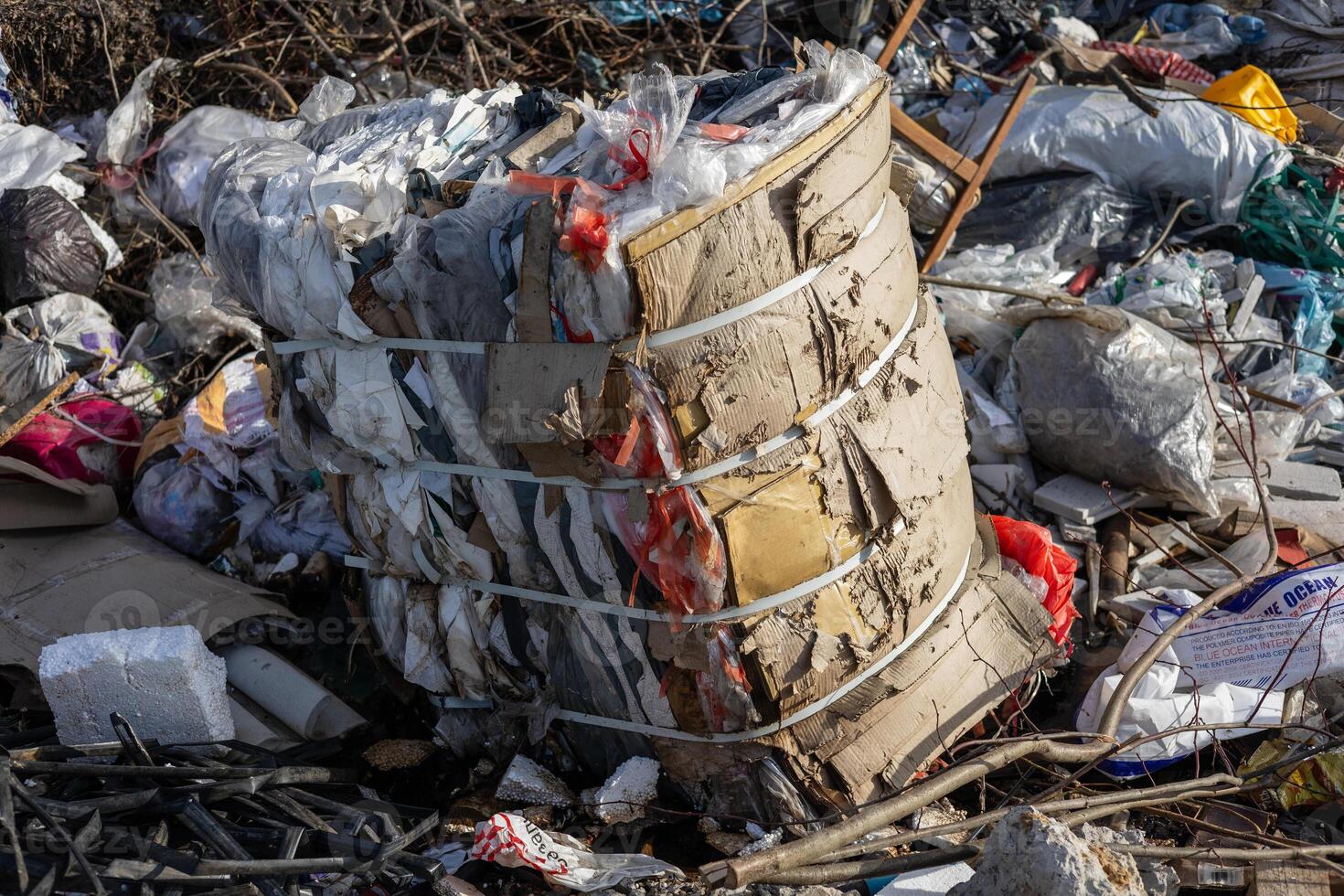 Trash and recyclable materials are seen stacked at a waste management site during daylight, highlighting urban waste challenges photo