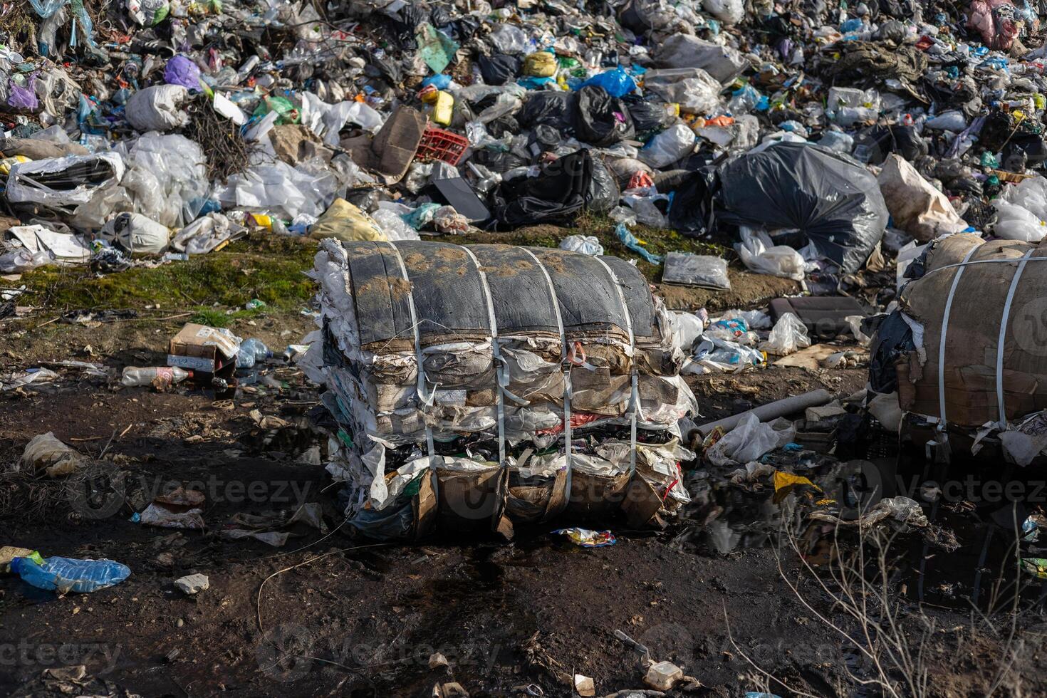 Piles of mixed debris and plastic at a landfill showcase the urgent problem of waste management and its impact on the ecosystem photo