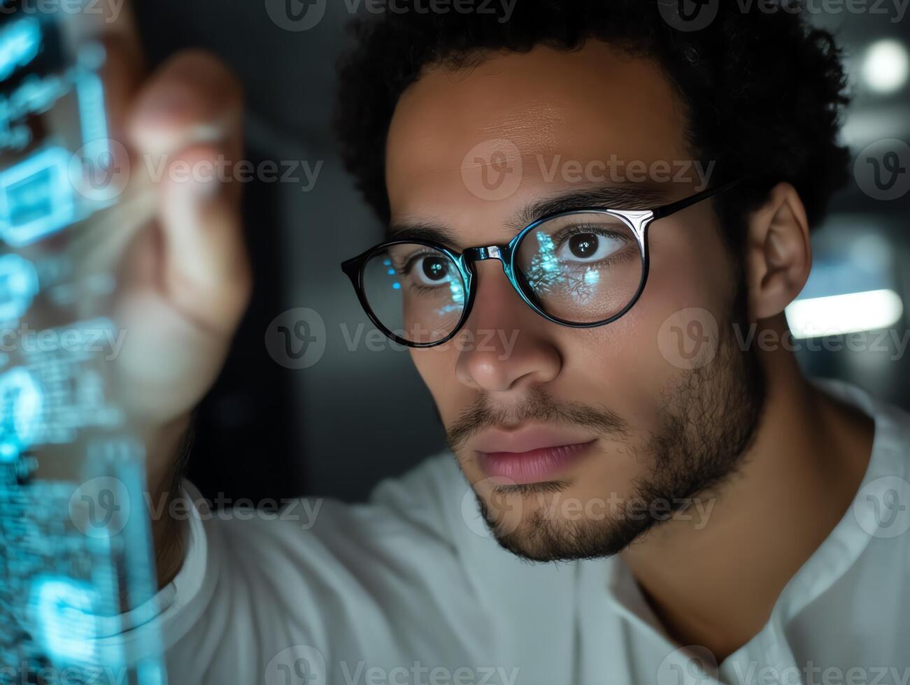 Focused programmer analyzing data on a digital screen. photo