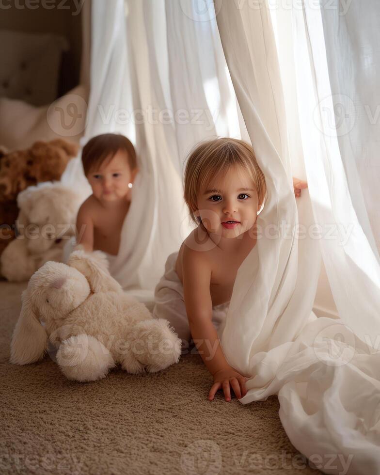Two toddlers playing peek-a-boo behind sheer curtains. photo