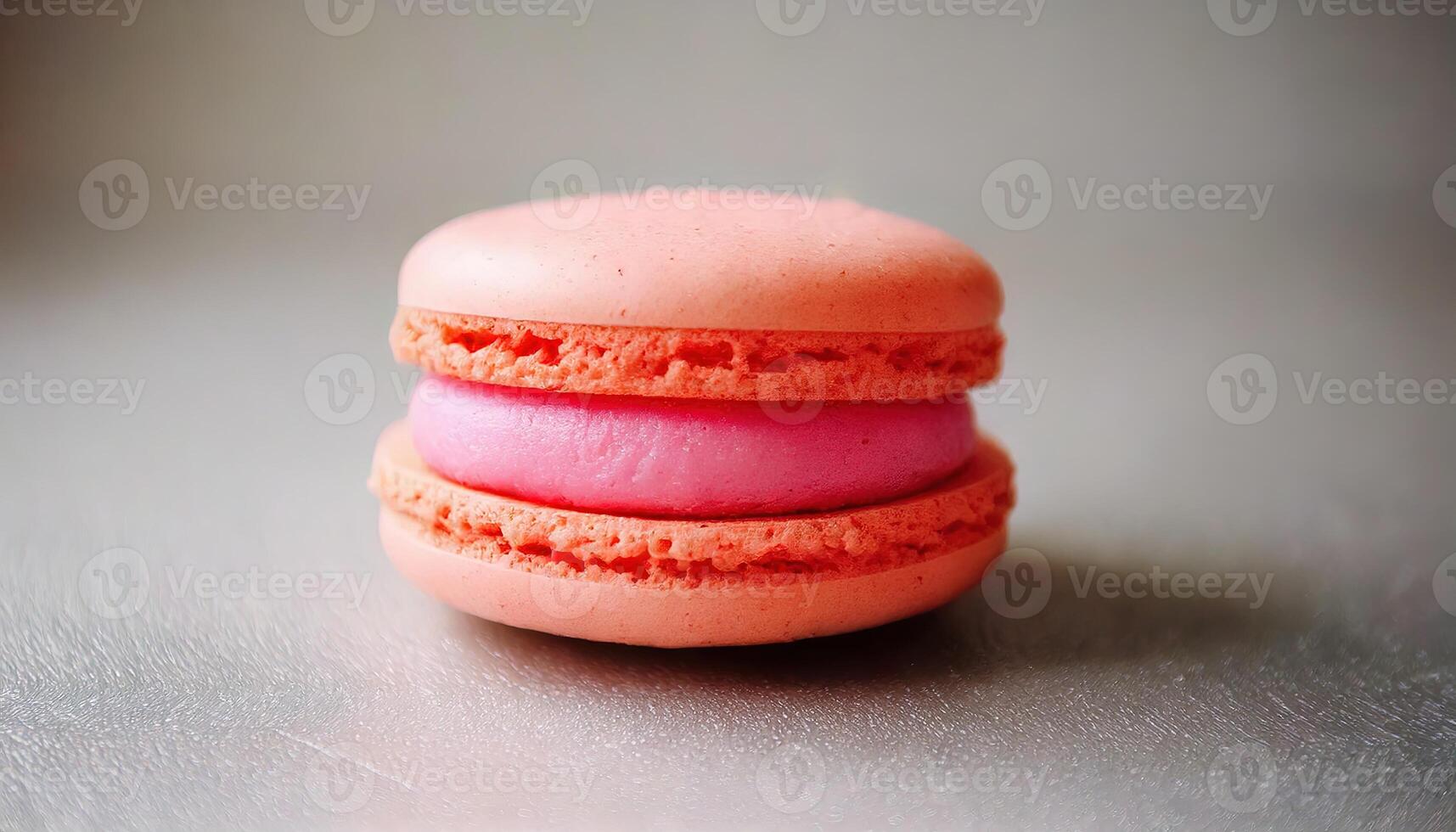 Bright pink macaron dessert on dark background with soft colorful lighting. photo