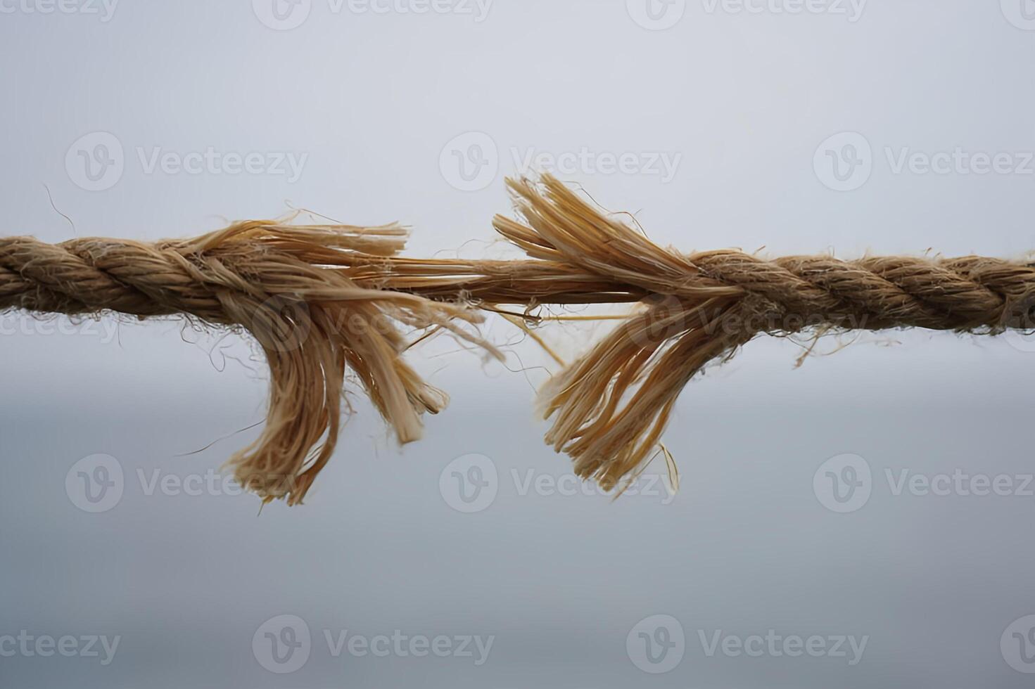Torn rope showing risk danger threat breaking point conceptual image photo