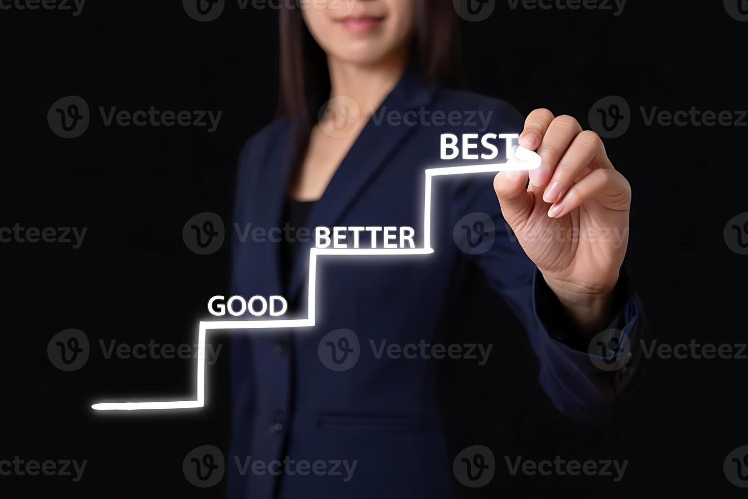 Businesswoman drawing staircase representing steps from good to better to best in a concept of improvement and achievement on a black background photo