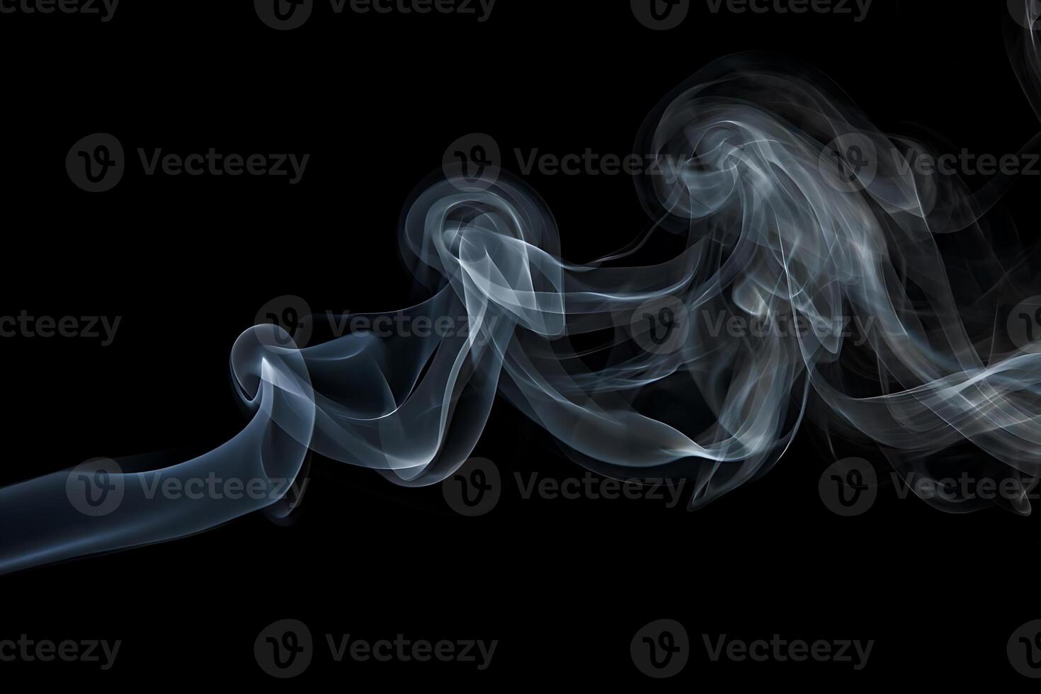 Abstract swirling wisps of elegant smoke gracefully move across a black background creating an artistic and ethereal visual photo