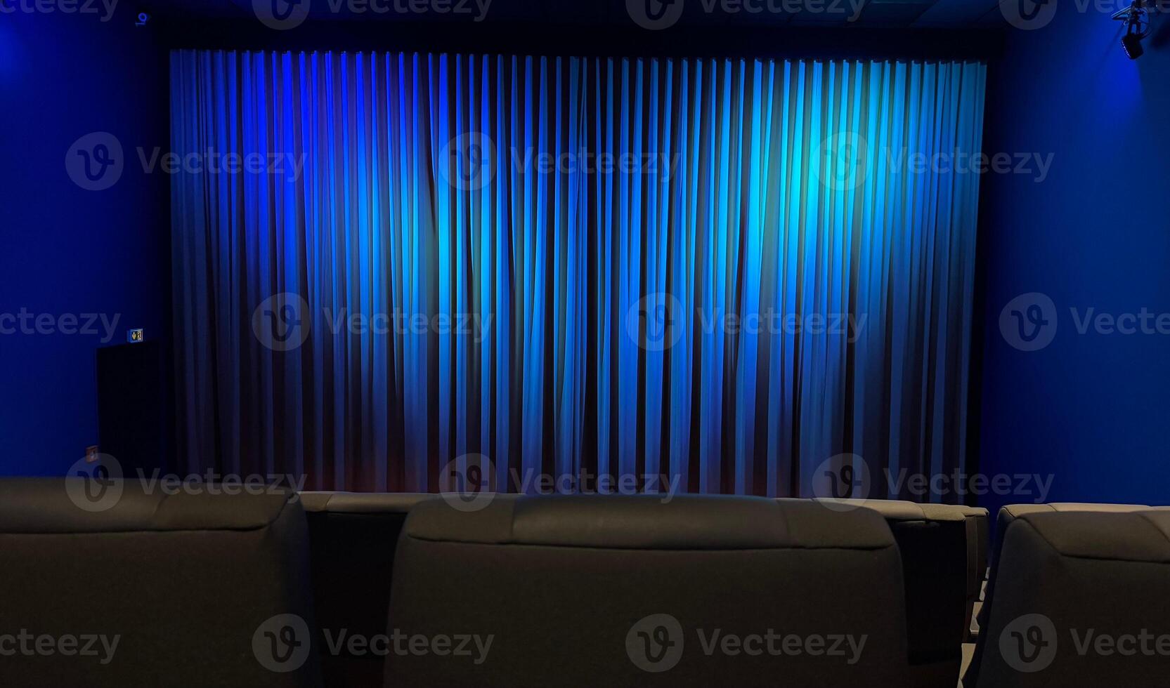 Empty Cinema Theater With Blue Curtains and Comfortable Seating photo