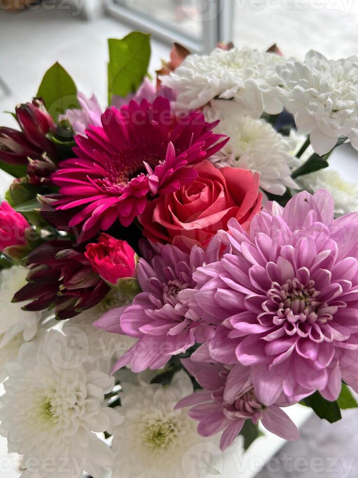 Vibrant bouquet of assorted flowers featuring pink gerbera daisies and delicate white chrysanthemums photo