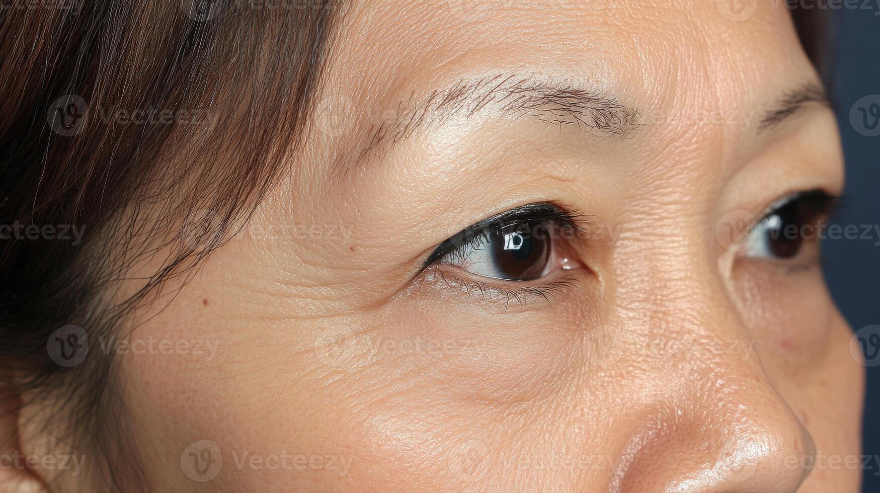 Close-up view of a person's face, focusing on the eyes and wrinkles. photo
