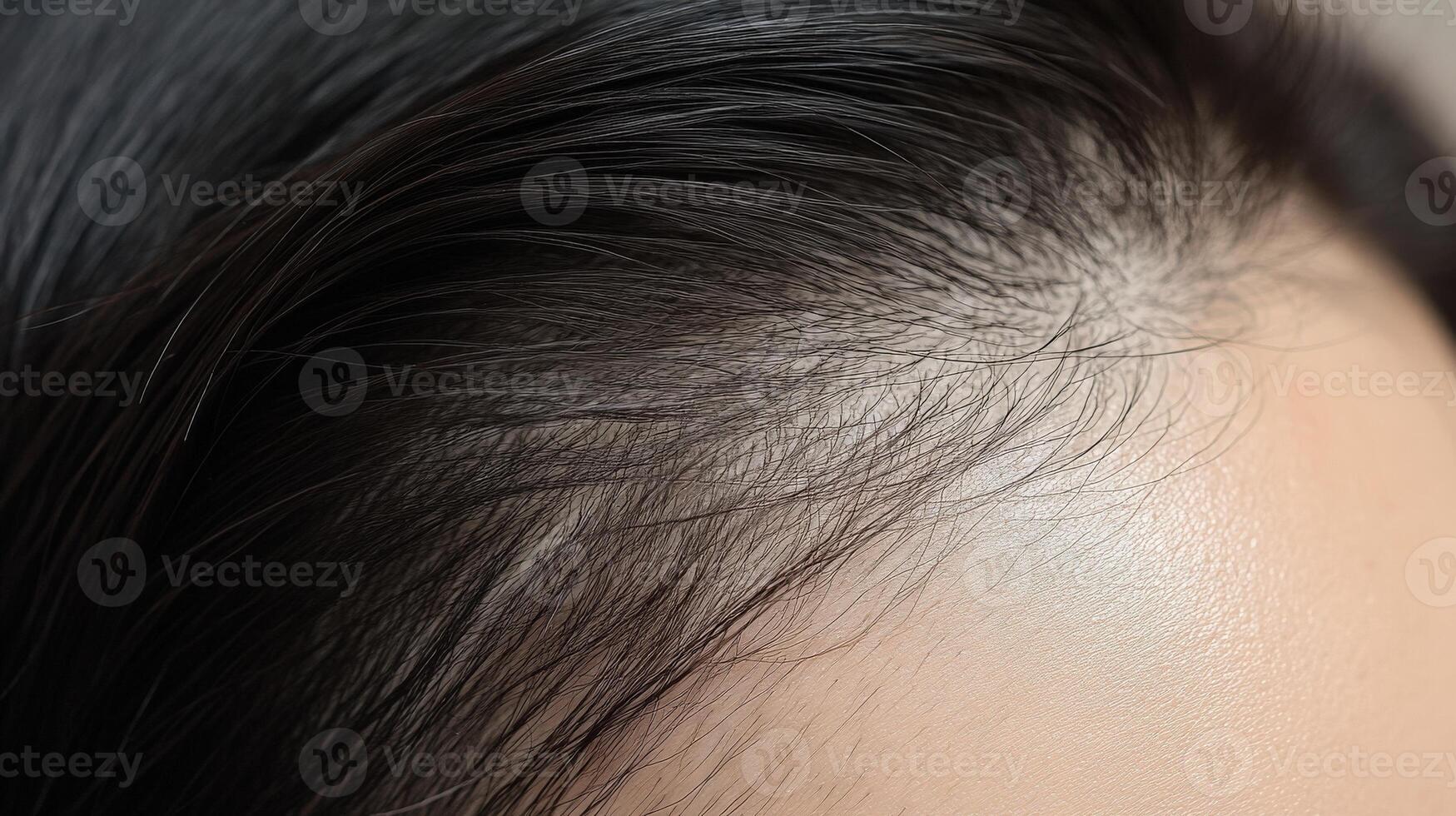 Close-up view of a woman's scalp and hair line. photo