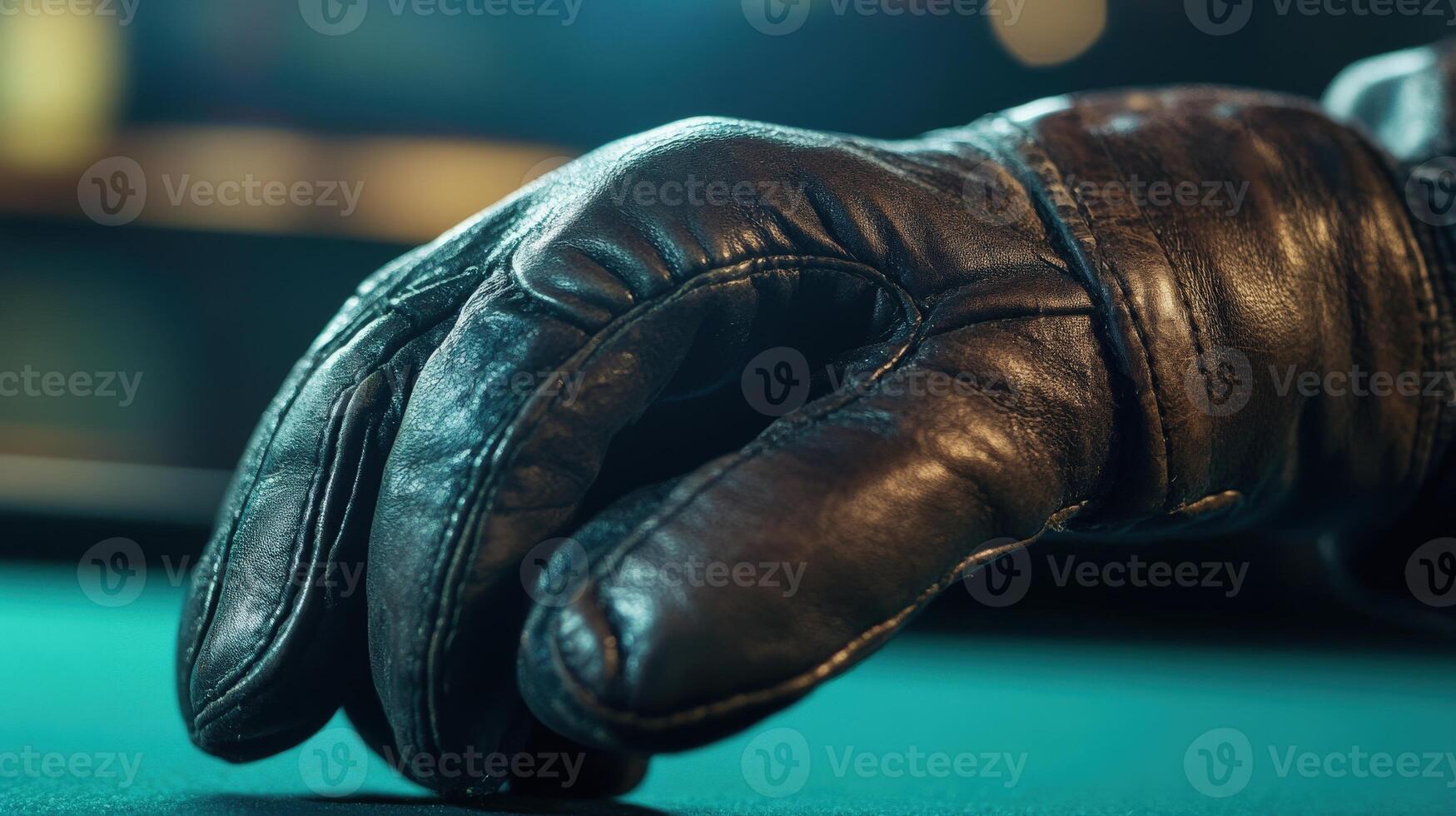 Close-up view of a dark brown leather glove on a pool table. photo