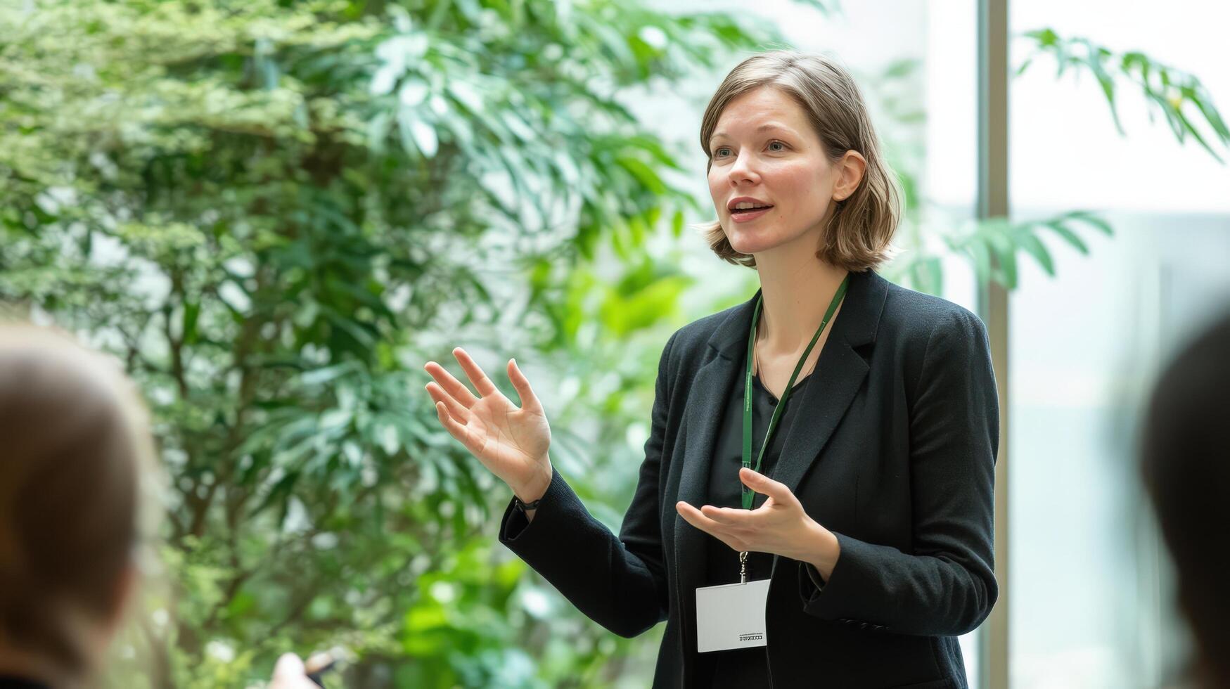 A woman in a business suit giving a presentation confidently photo
