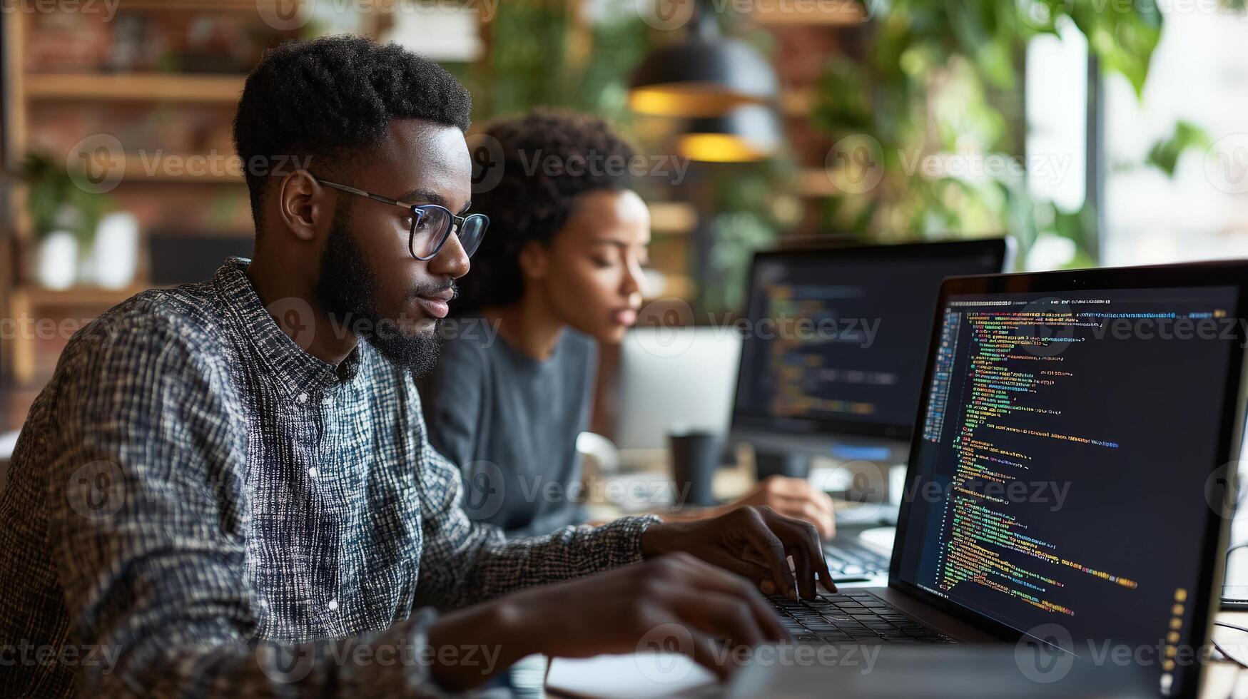 Focused individuals working on computers in a modern workspace. photo