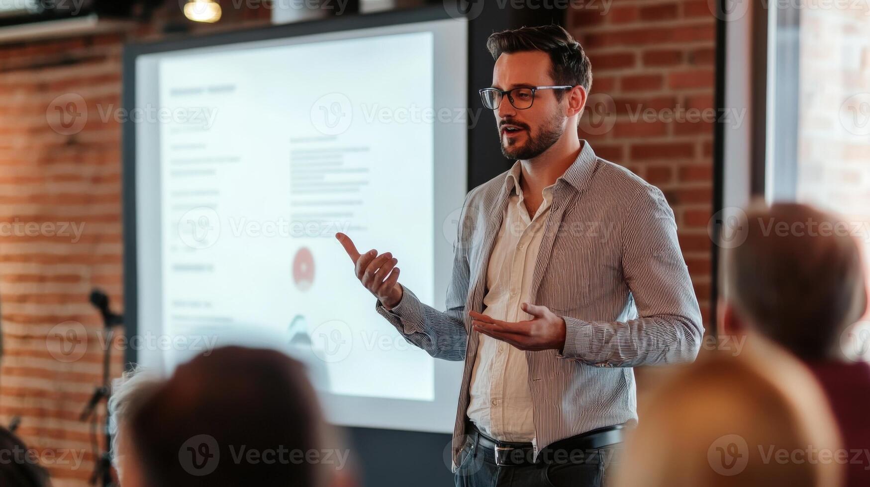 A man giving a presentation to an audience indoors photo