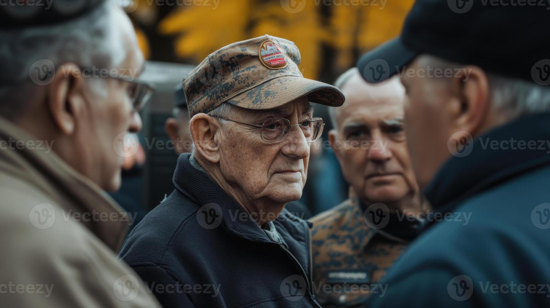 A group of older men are conversing in an outdoor setting photo