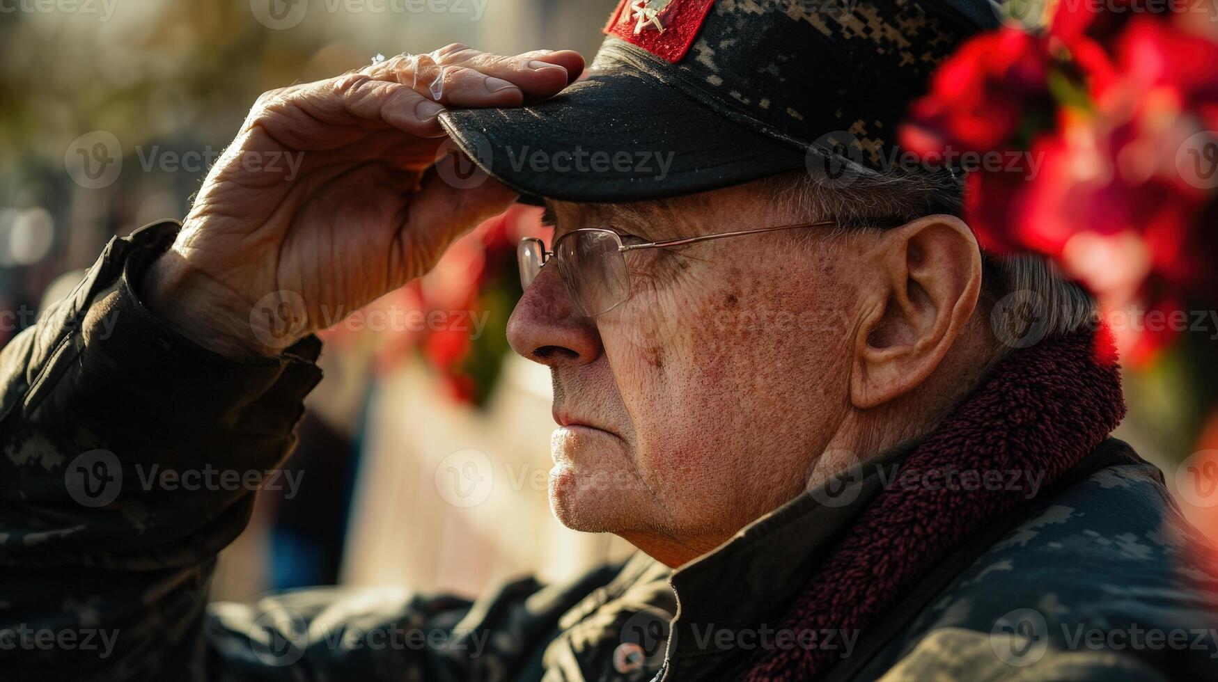 An elderly man in uniform salutes with a determined gaze photo