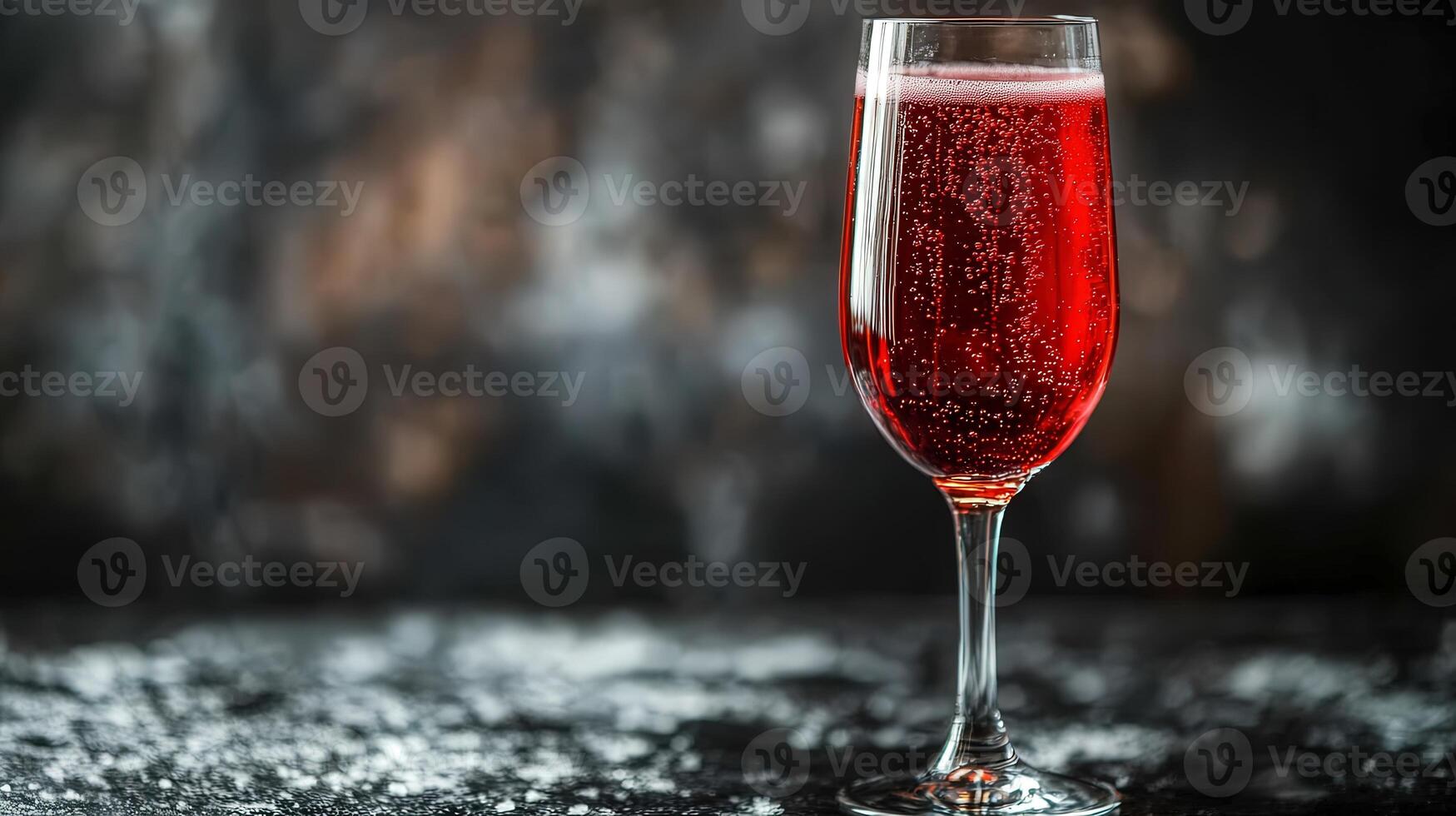 A tall glass of ruby red liquid with bubbles photo