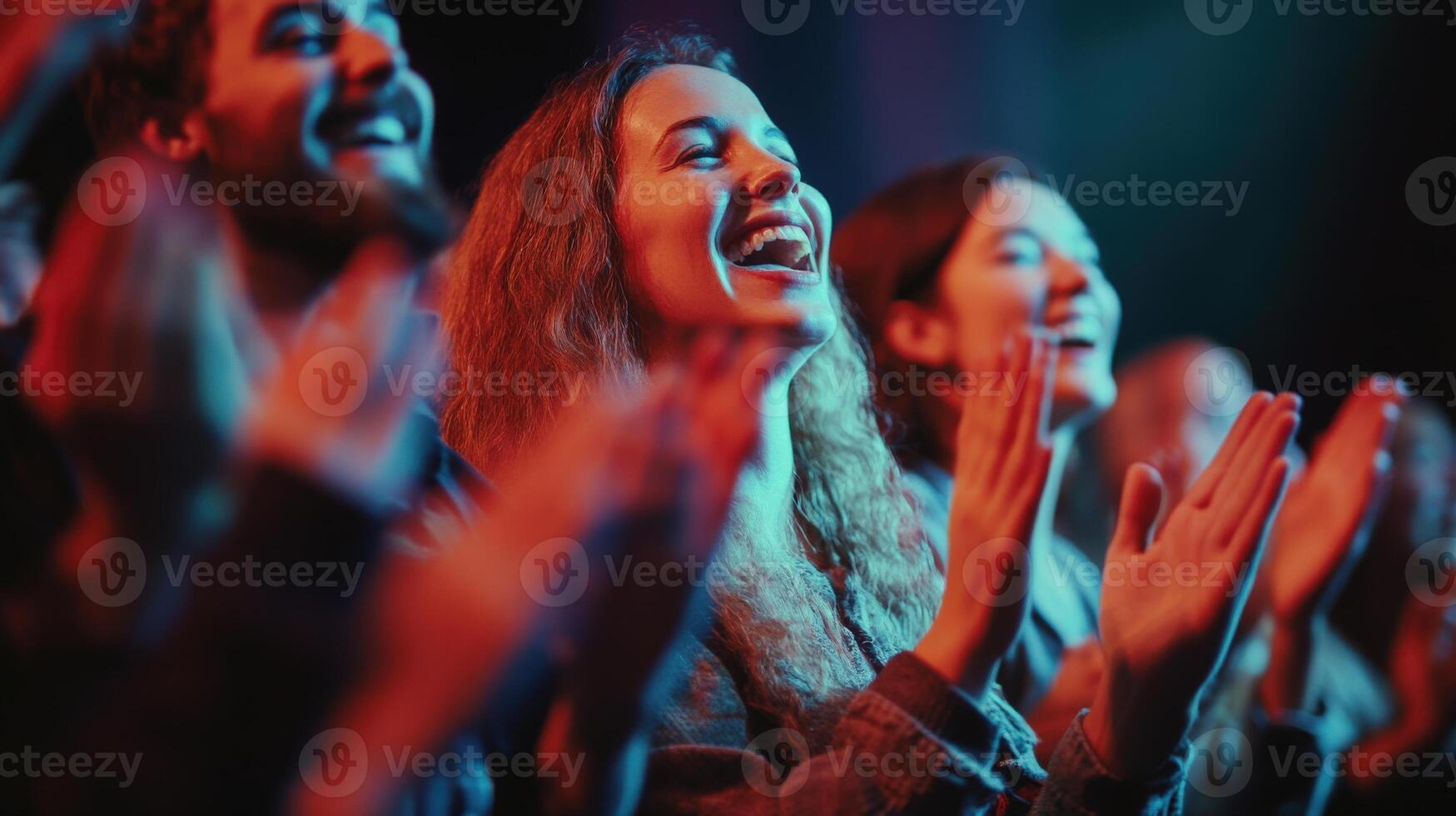 Energetic crowd applauding a performance. photo