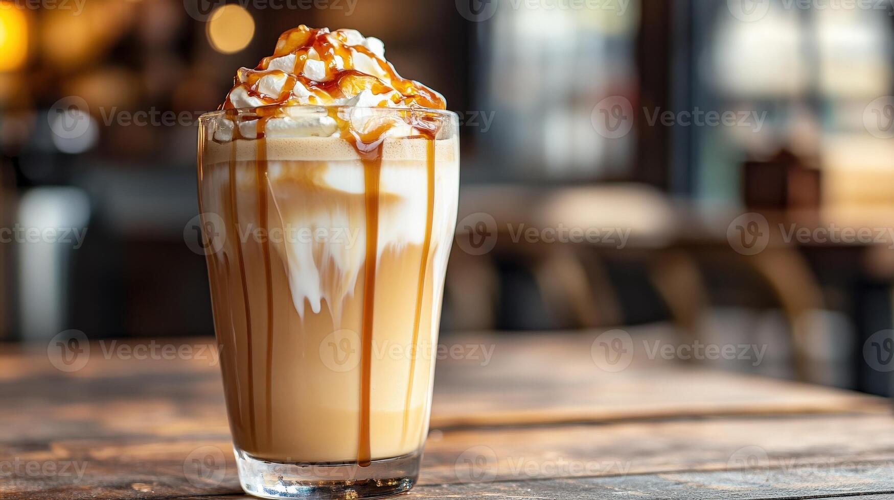 A tall glass of caramel coffee topped with whipped cream photo