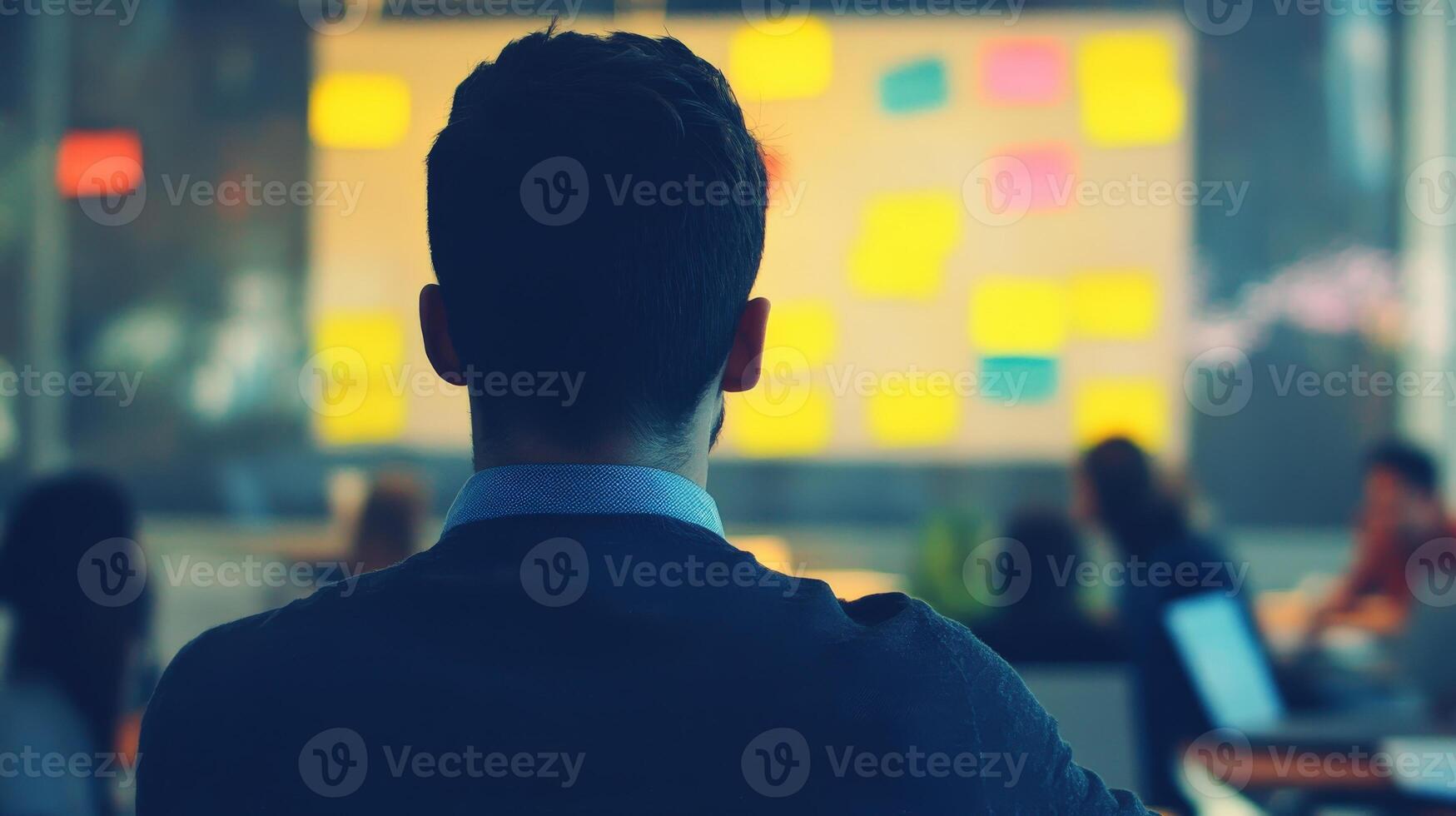 Rear view of a person listening to a presentation. photo