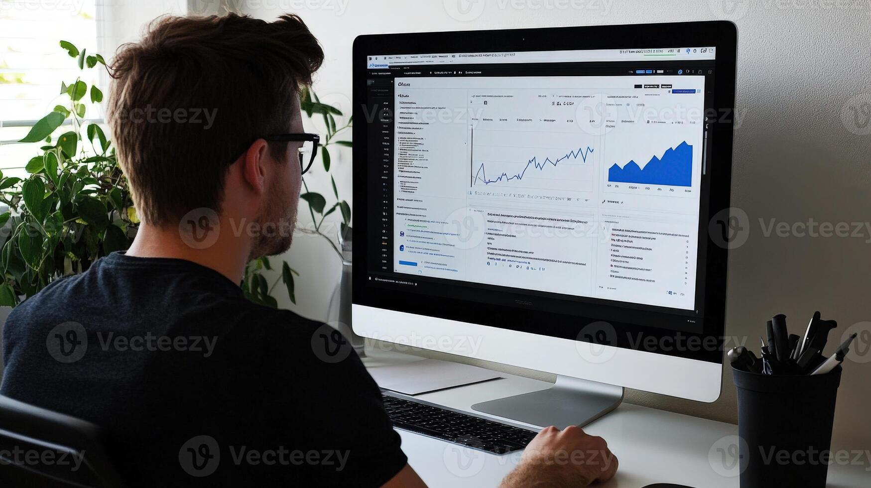 Focused individual observing financial data on a computer screen. photo