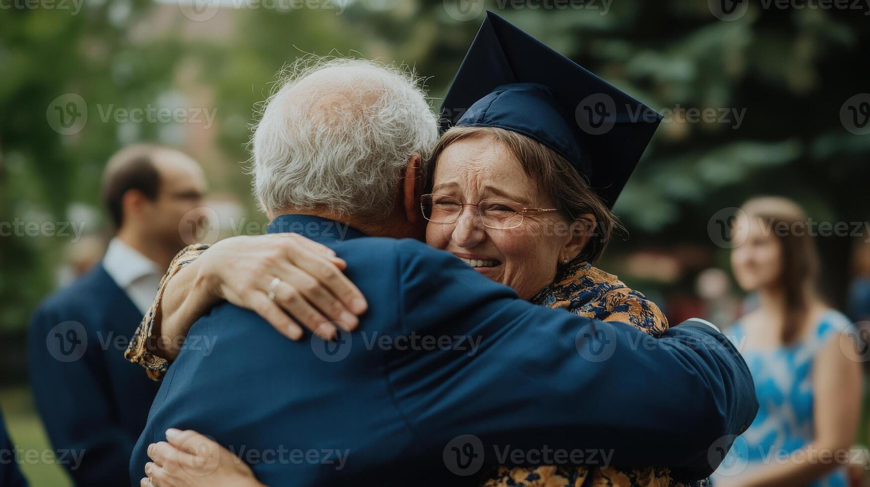 Proud grandparents embrace graduating student at outdoor ceremony. photo