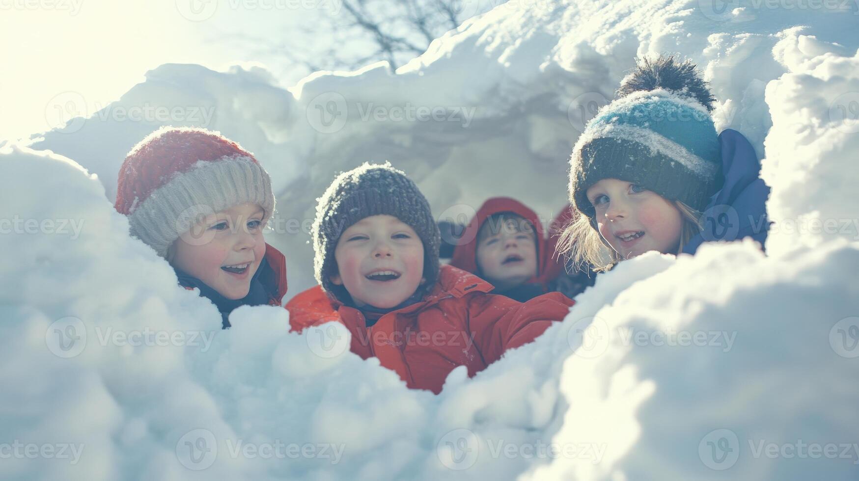 Playful children concealed in a snow fort. photo