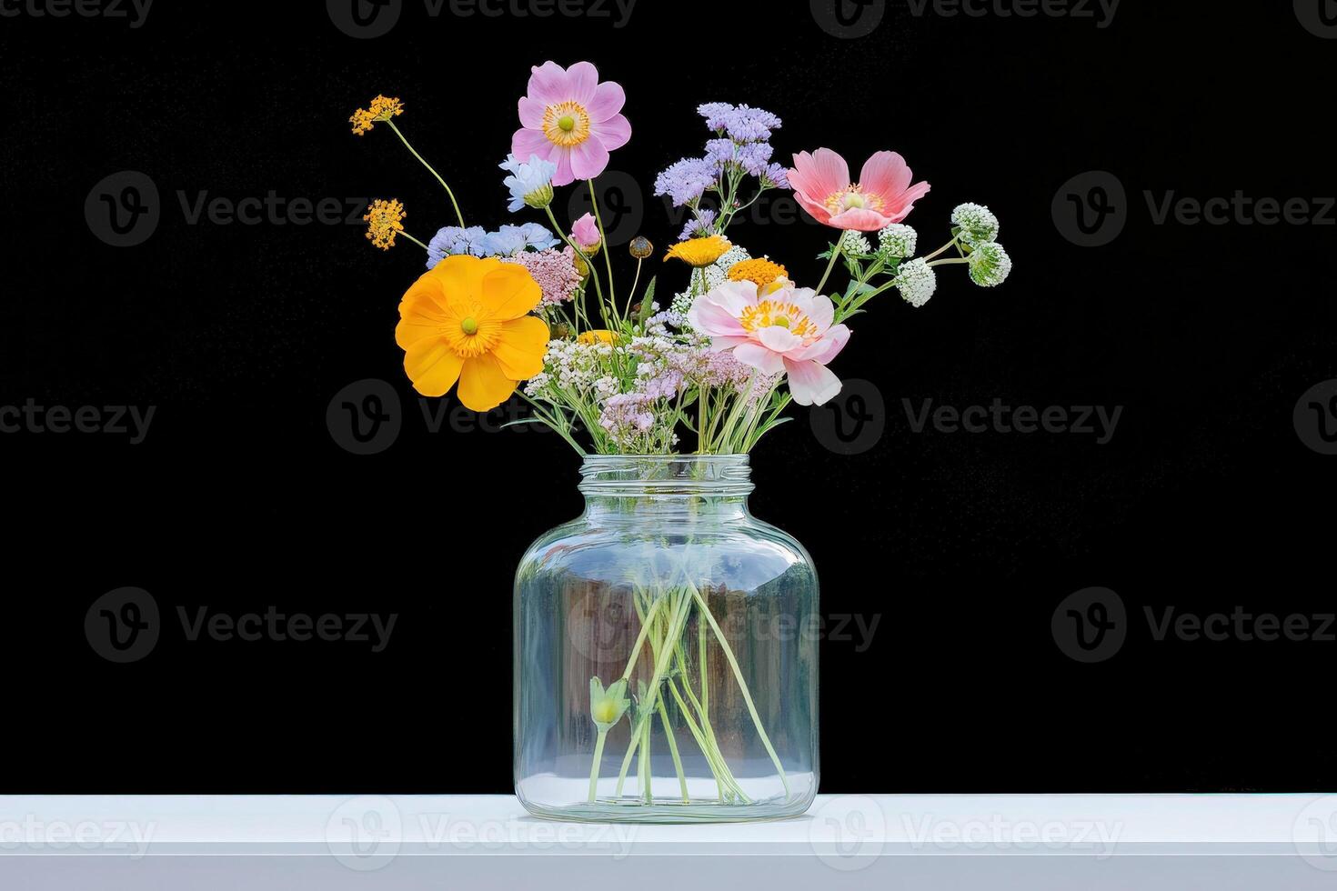 Mixed Flower Arrangement in Clear Glass Jar photo
