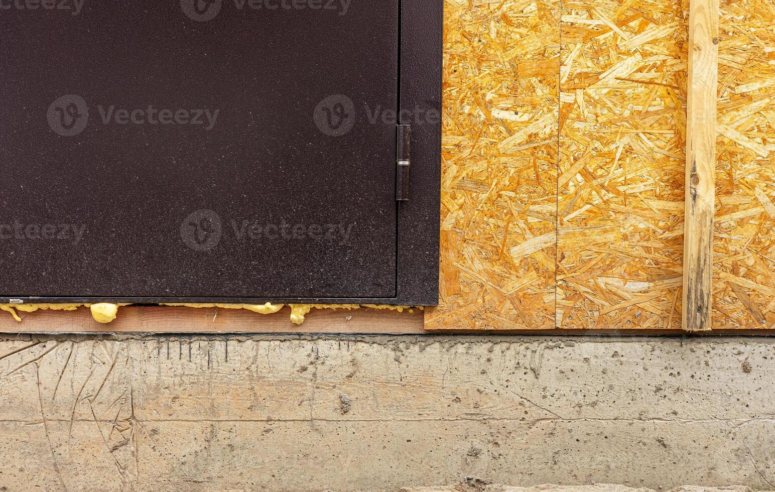 Waterproofing of the house foundation. Close-up of the house foundation with waterproofing photo