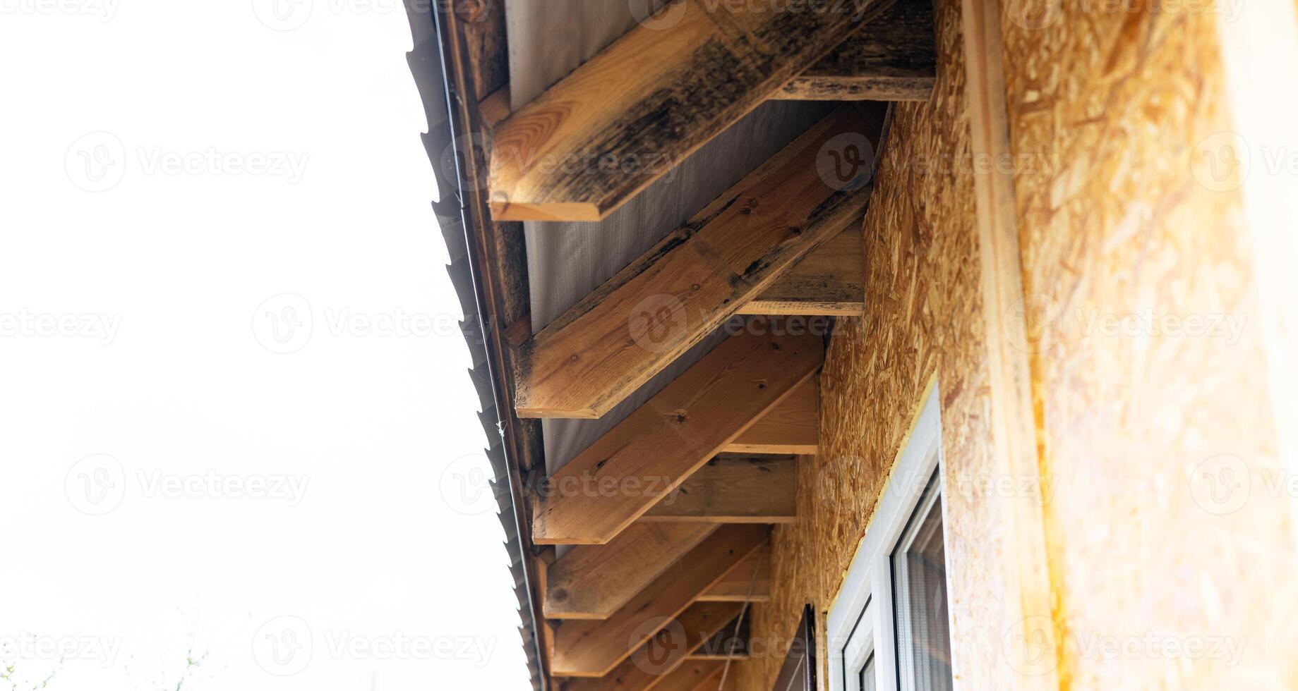 a wooden beam on the side of a building. photo