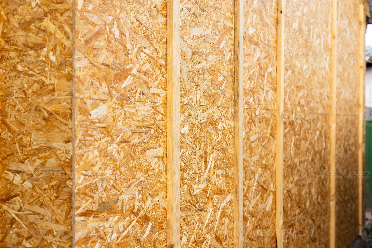 OSB panels. The walls of the frame house are sheathed with OSB boards for further finishing. Construction of frame houses and their cladding. photo