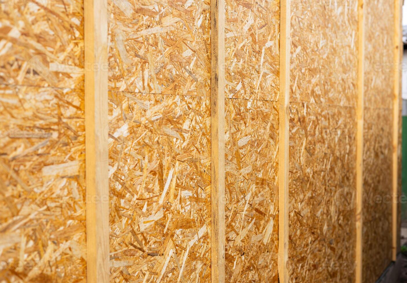 Sheathing of the house with OSB panels The walls of the frame house are sheathed with OSB boards for further finishing. Construction of frame houses and their cladding. photo