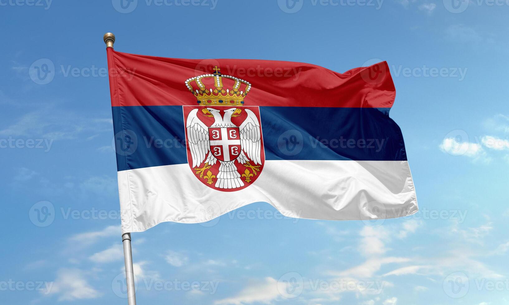 Serbian national flag waving in the sky photo