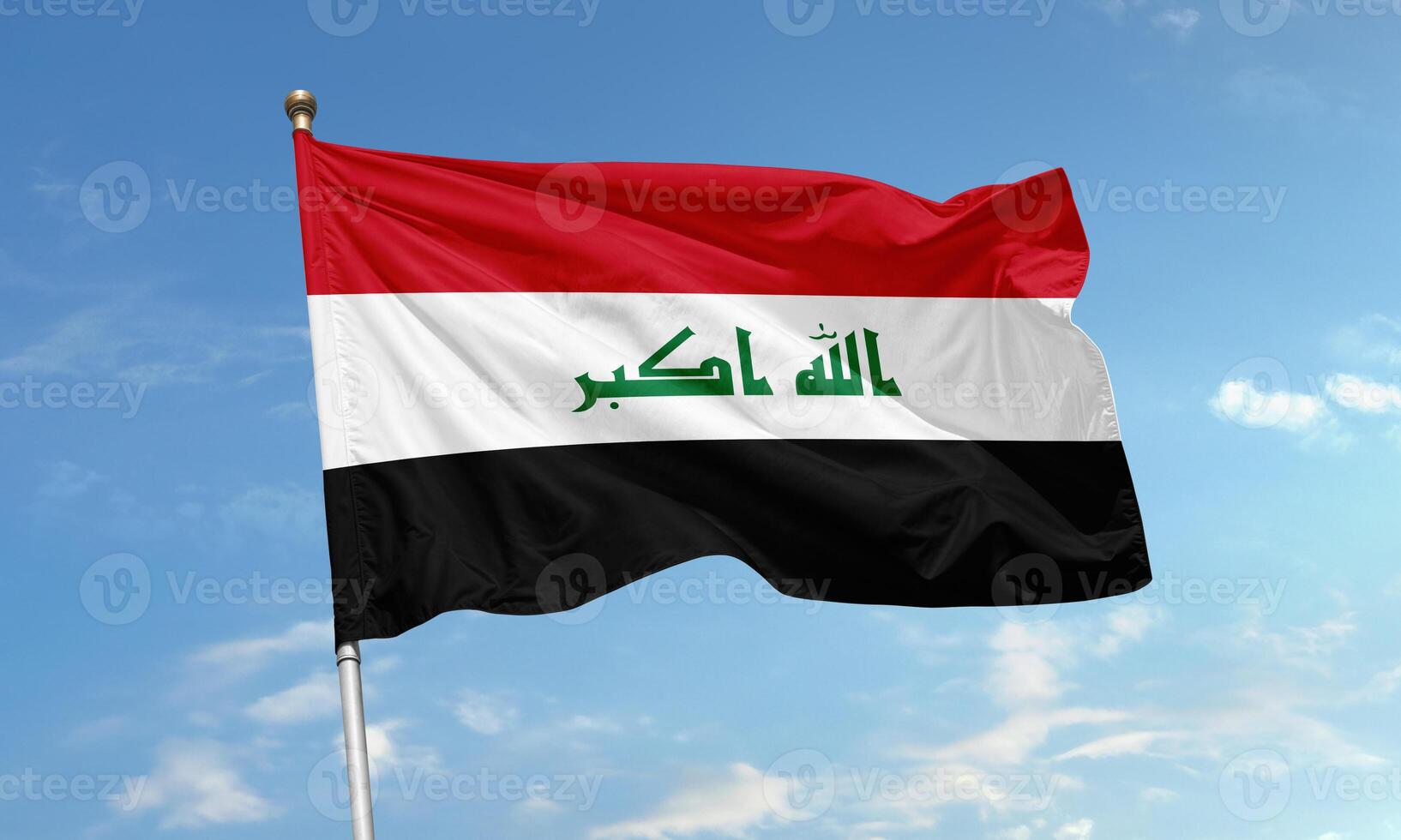 Iraqi national flag with Arabic inscription flying photo