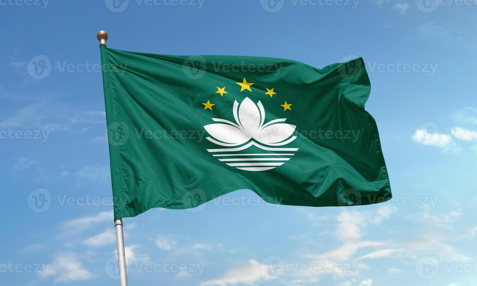 Macau regional flag with lotus flower and stars waving in daylight sky photo