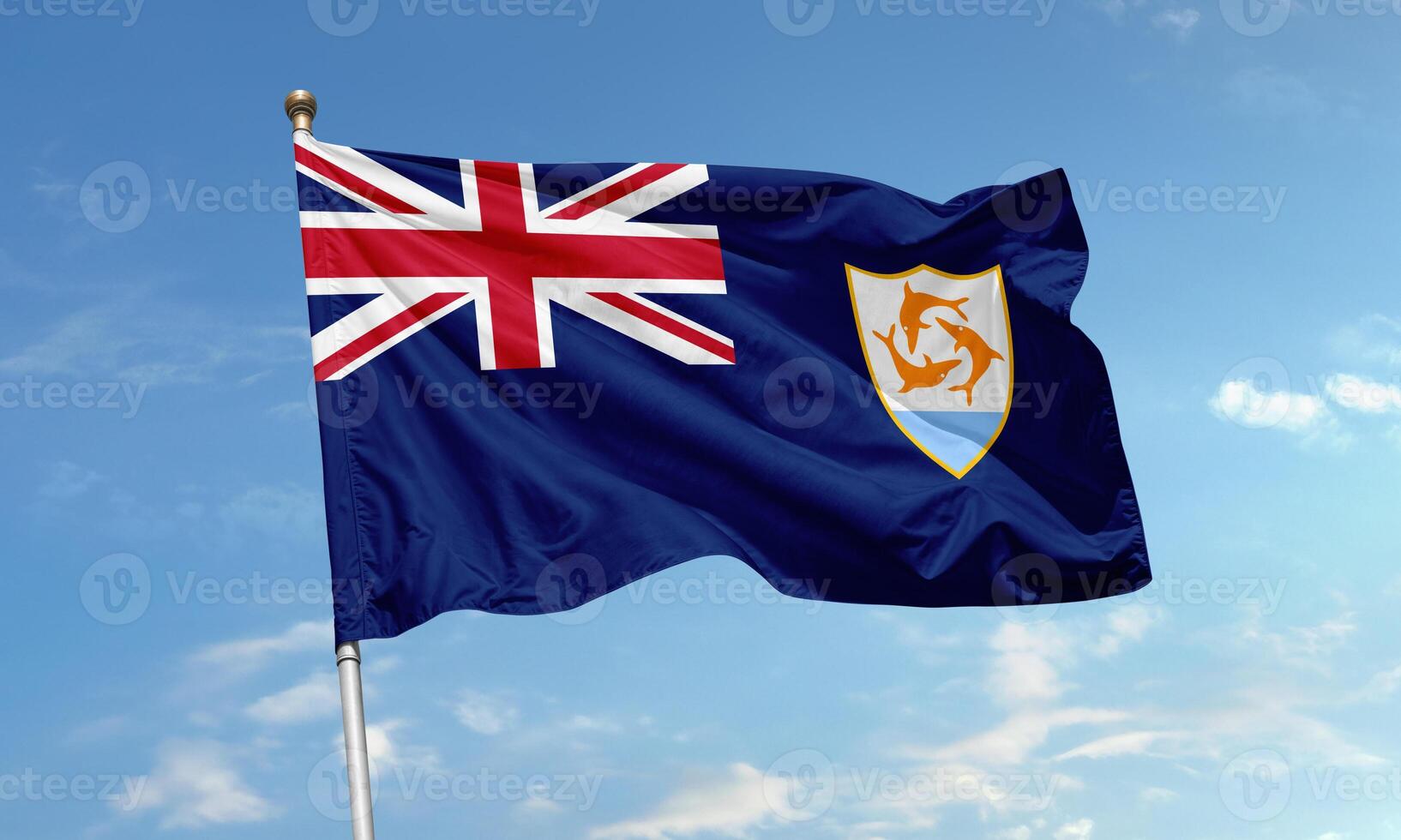 Anguilla national flag waving in the wind featuring Union Jack and dolphin emblem on blue background photo