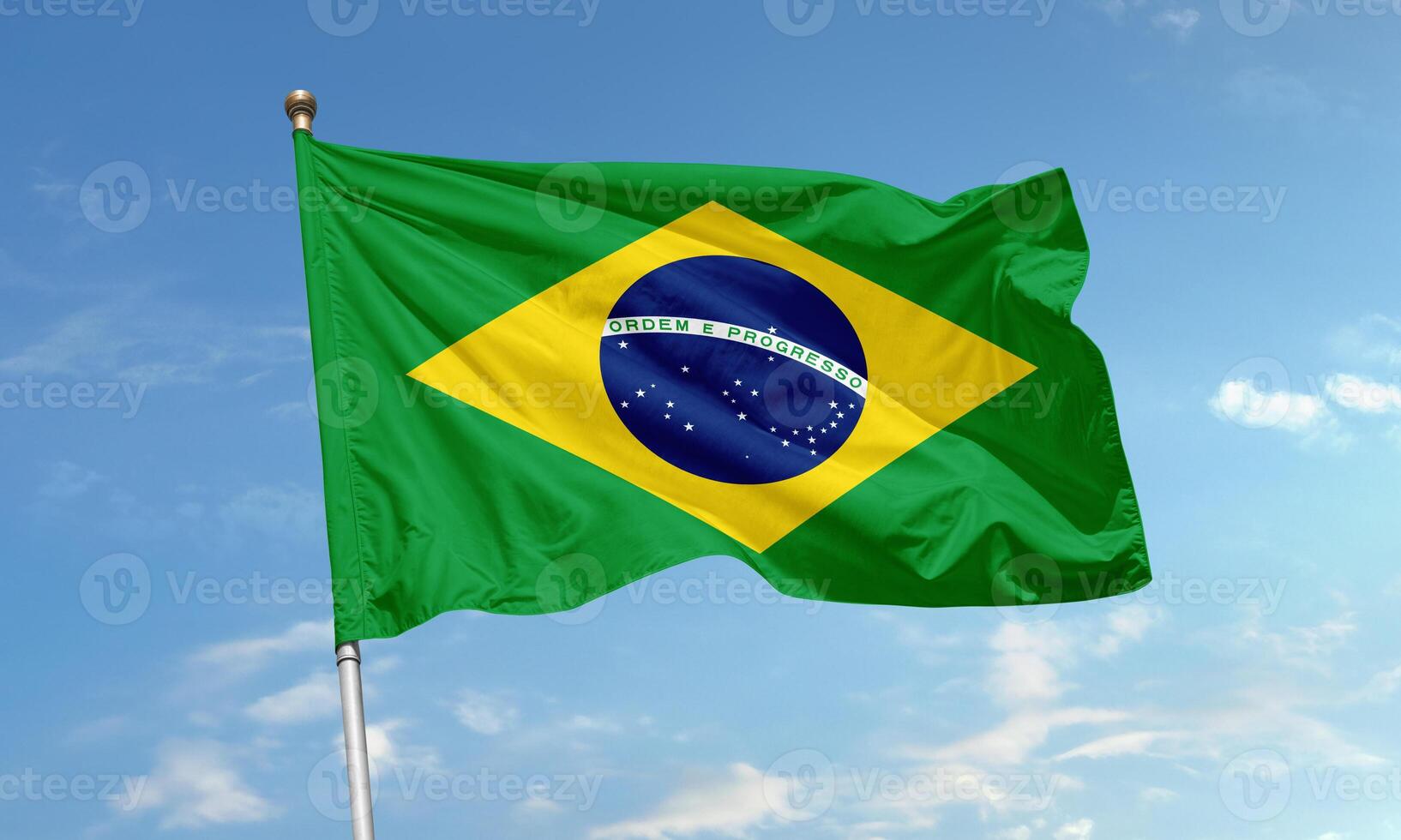 Brazil national flag with green field, yellow diamond and starry blue globe waving proudly in the clear sky photo
