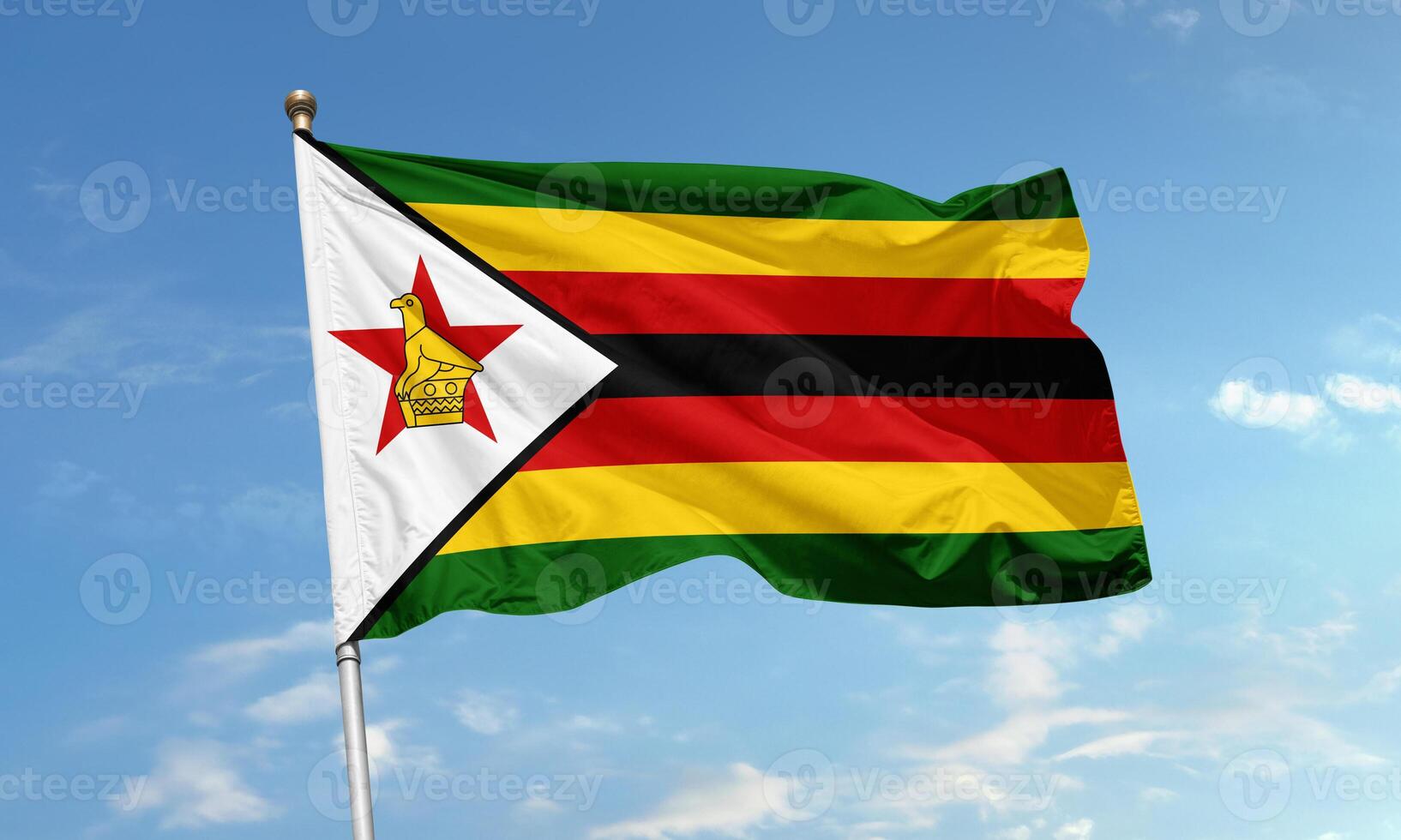 Zimbabwe national flag waving in clear sky photo