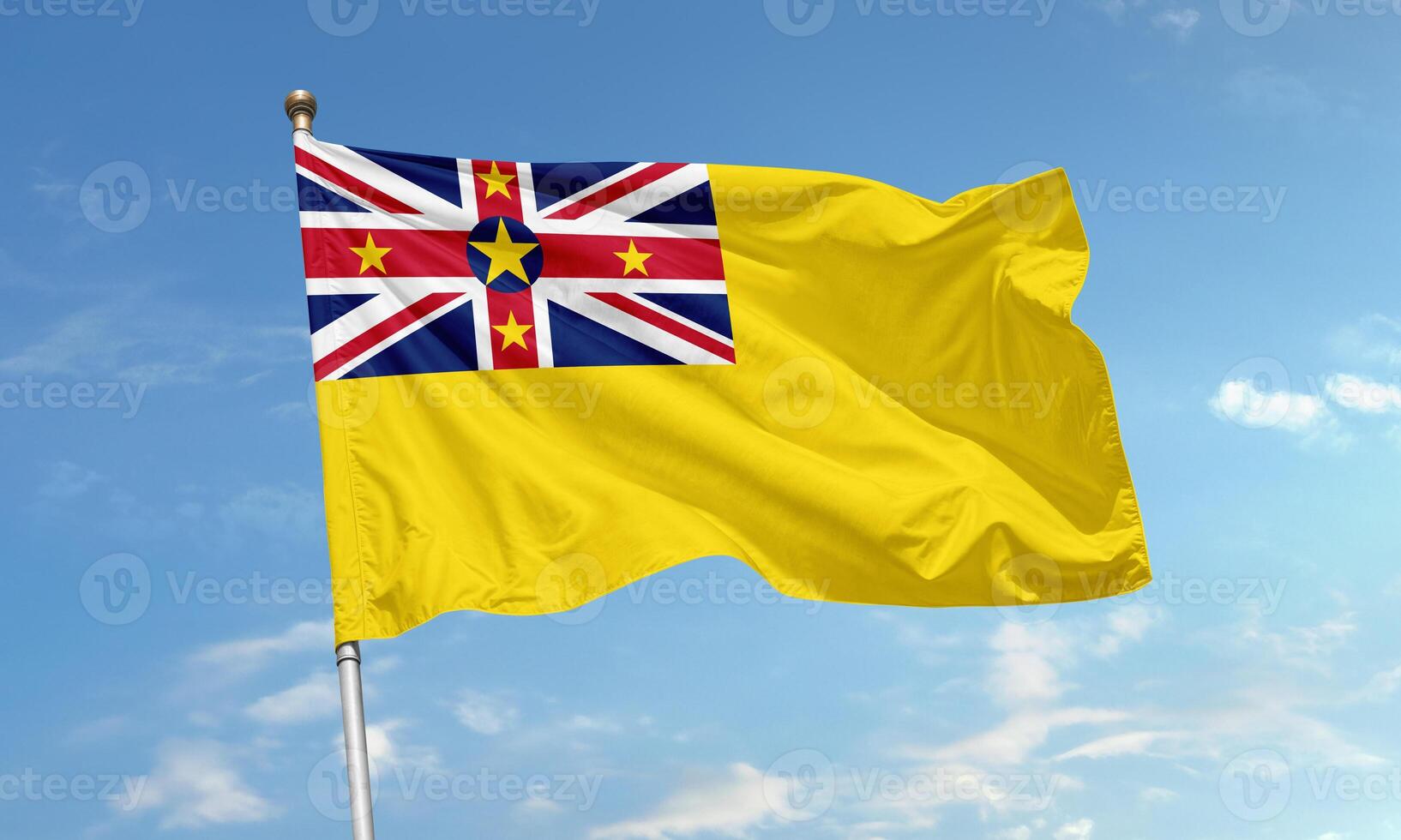 Niue flag with Union Jack and yellow field flying photo