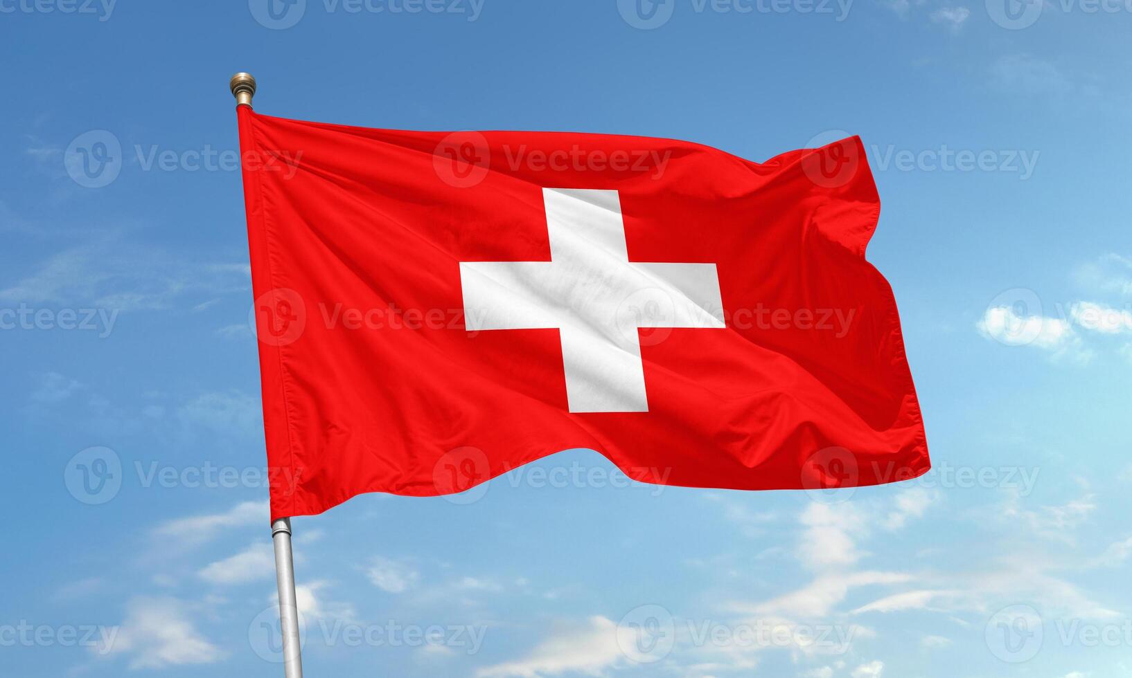 Switzerland national flag with white cross on red flying in the wind photo