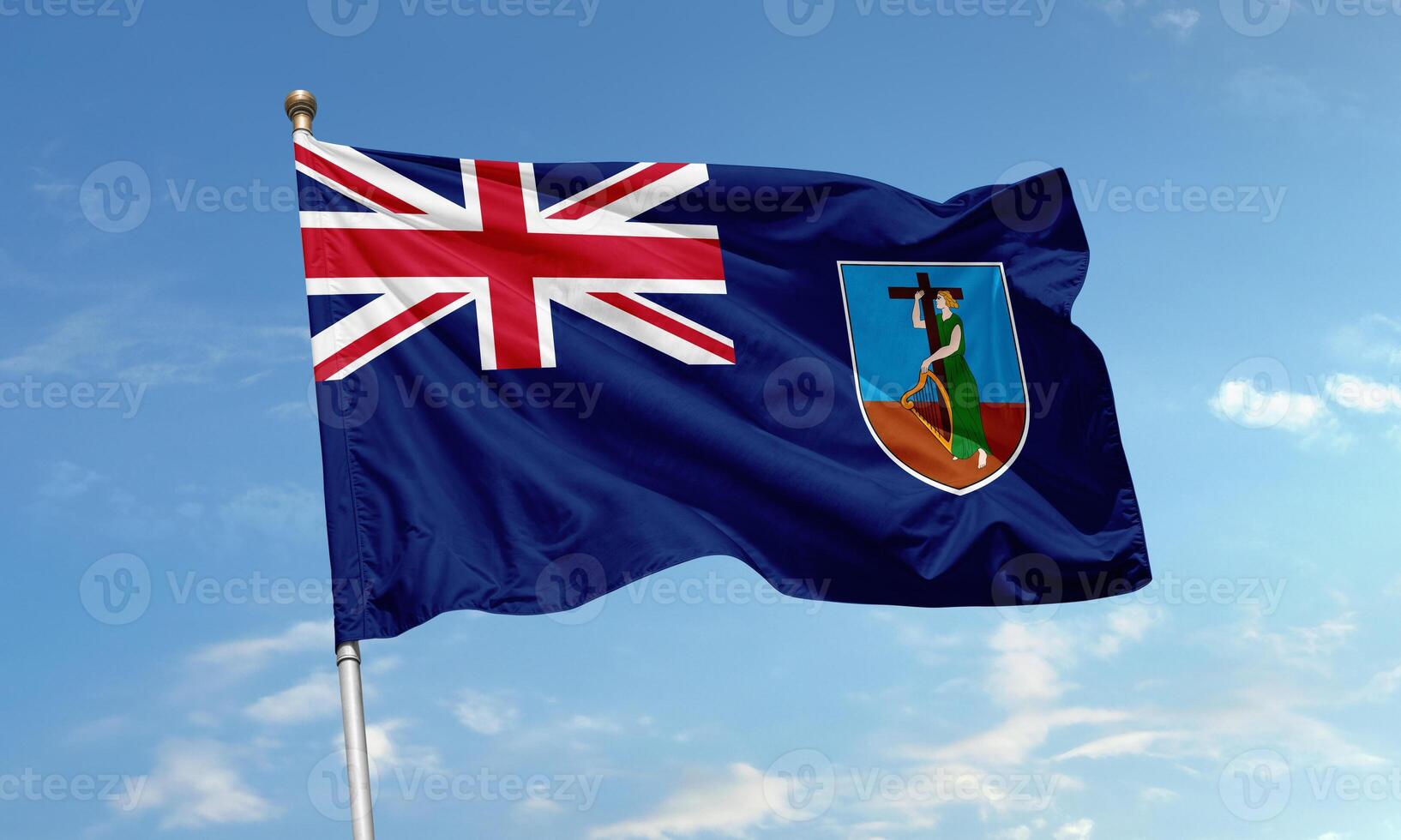 Montserrat flag waving against sky with Union Jack and island emblem visible photo