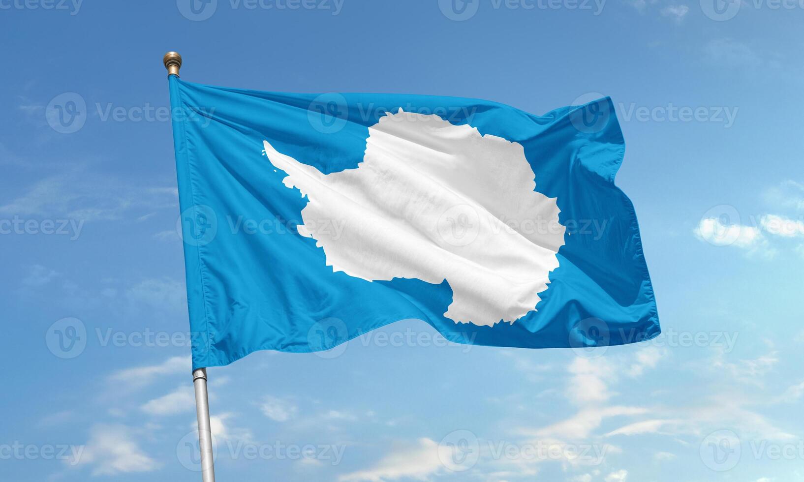 Antarctica flag fluttering in the sky showing the white continent silhouette on a blue background representing peace and neutrality photo