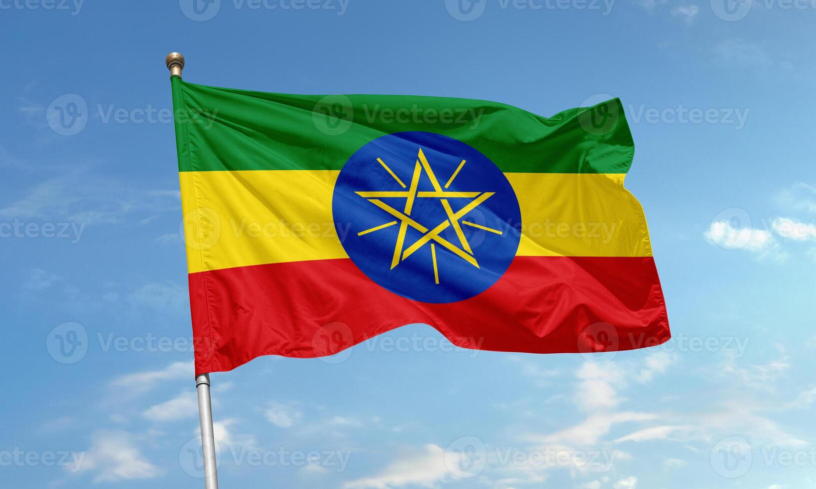 Ethiopian national flag with star emblem waving in the sky photo